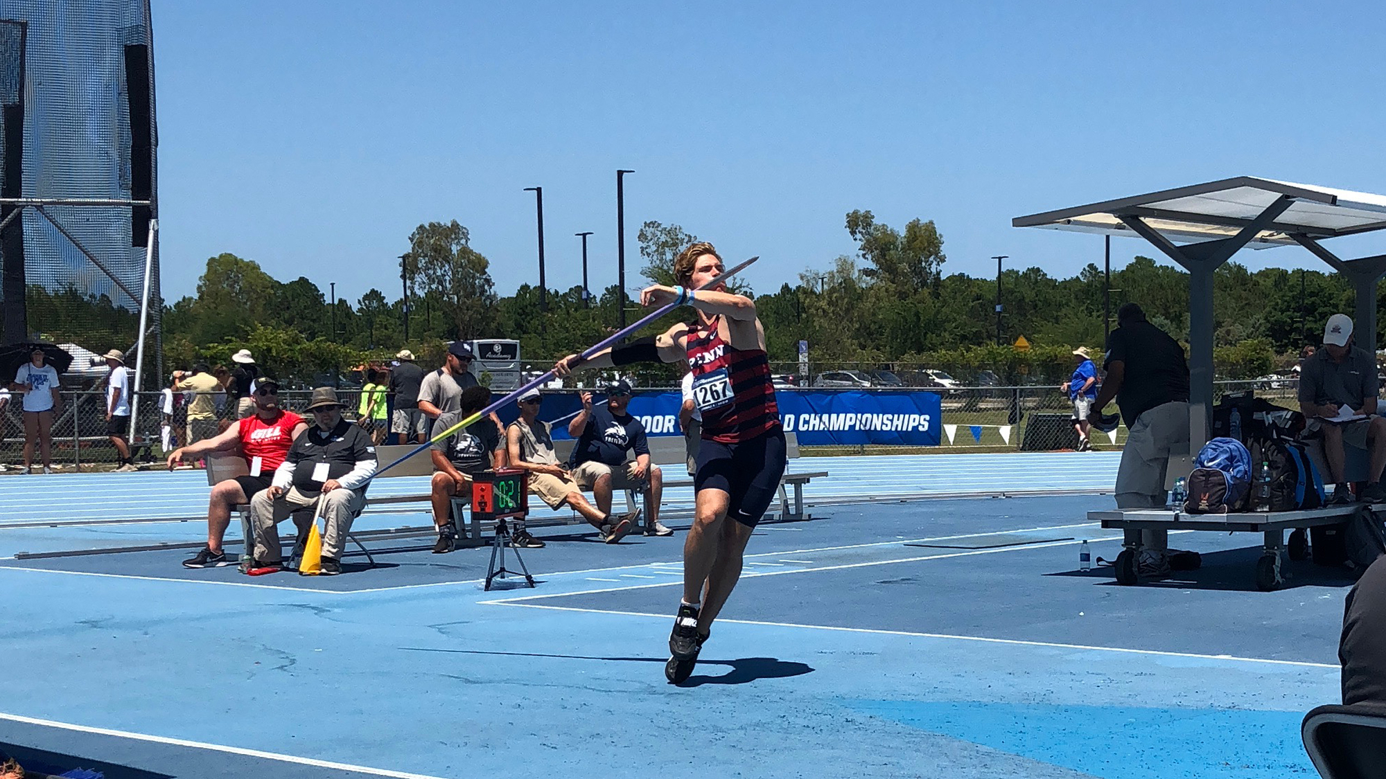 Minichello, during a meet, holds the javelin bar on his right shoulder.