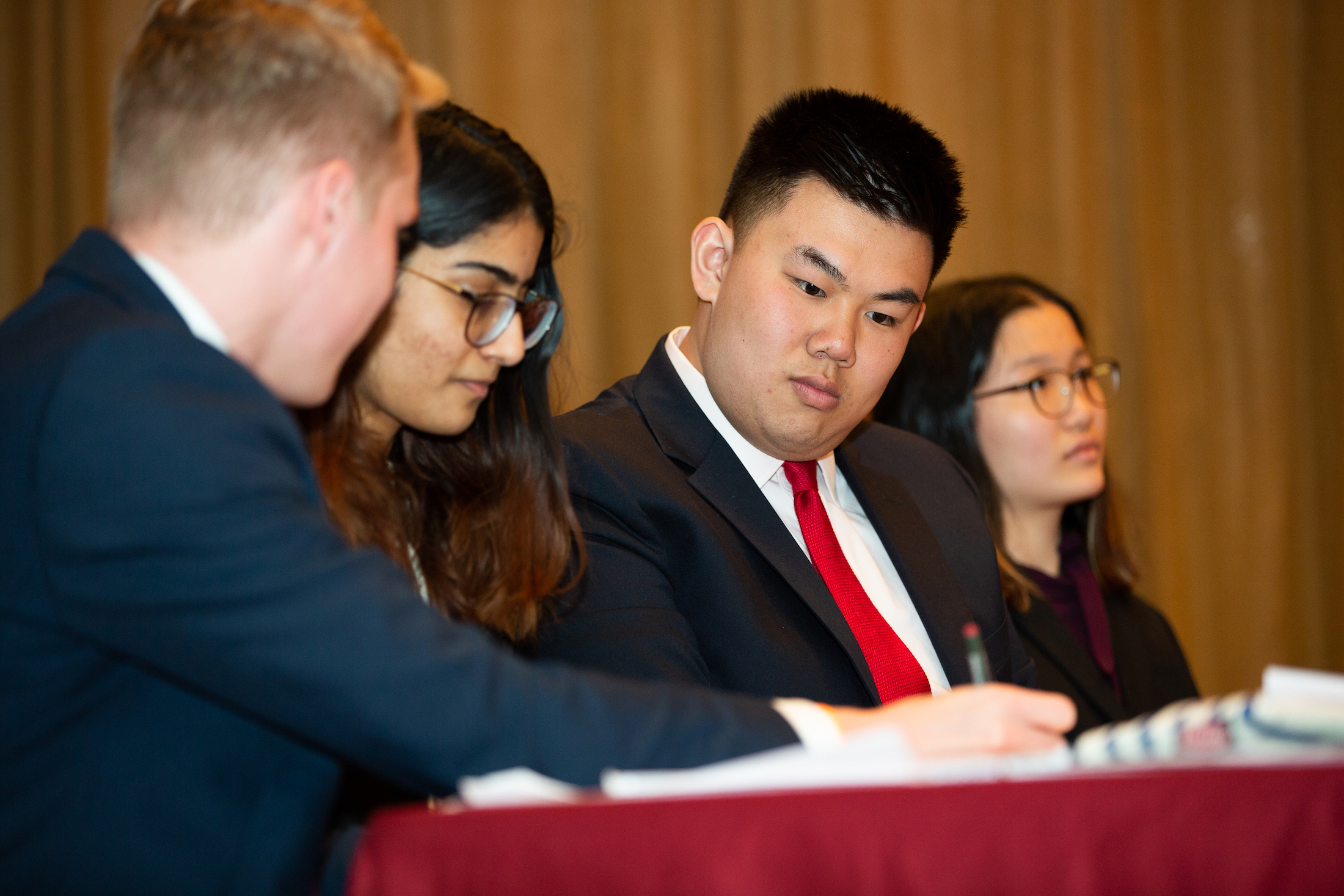 Member of the Penn Debate Society look at notes during a round with the Bard Prison Initiative Debate Union