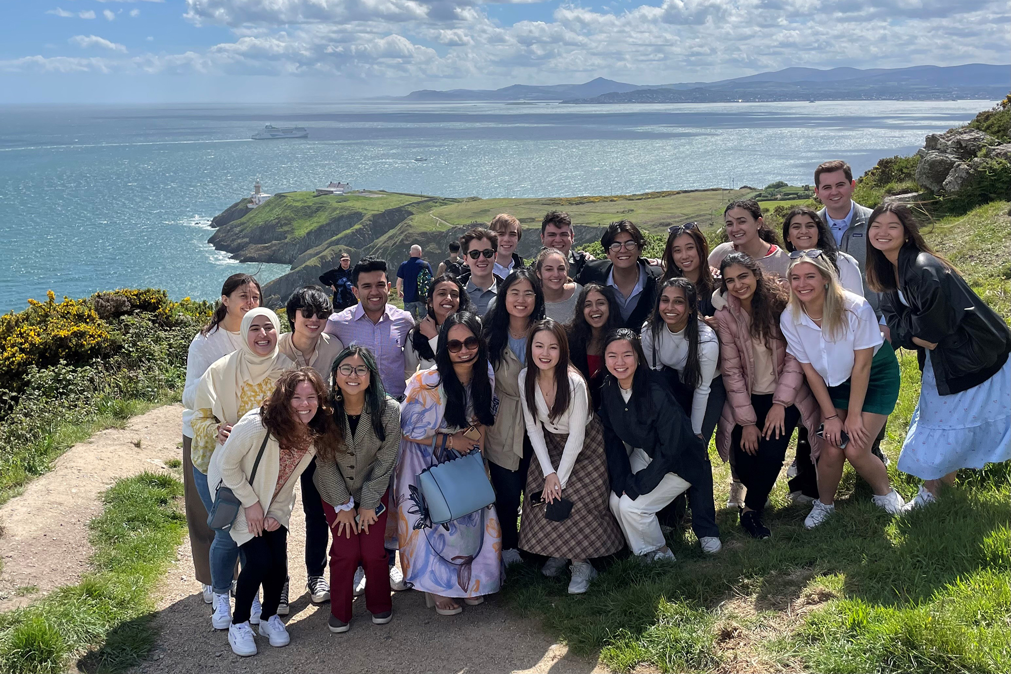 A group of Wharton students on a cliff in Ireland.