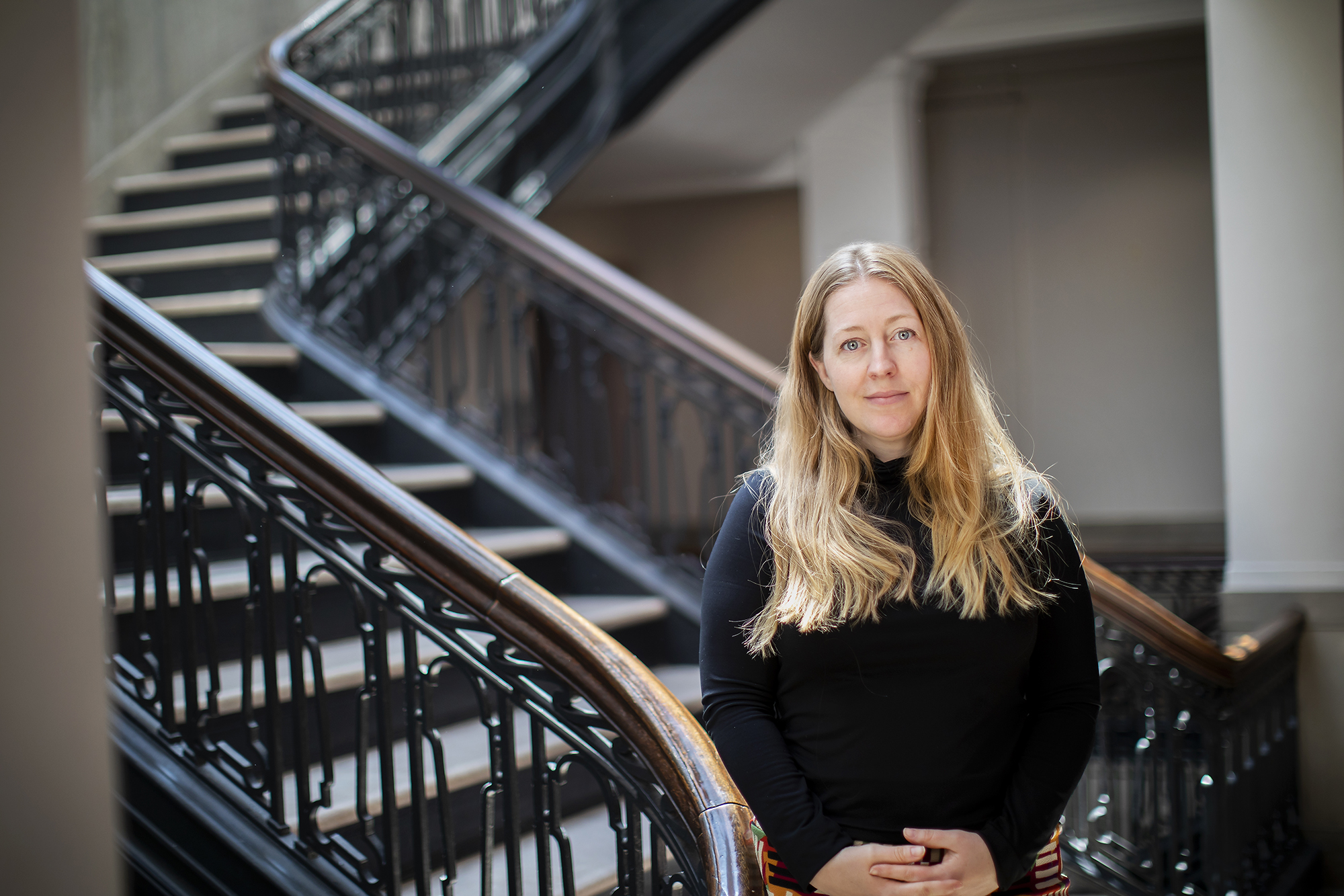 Whitney Trettien standing in a stairwell.