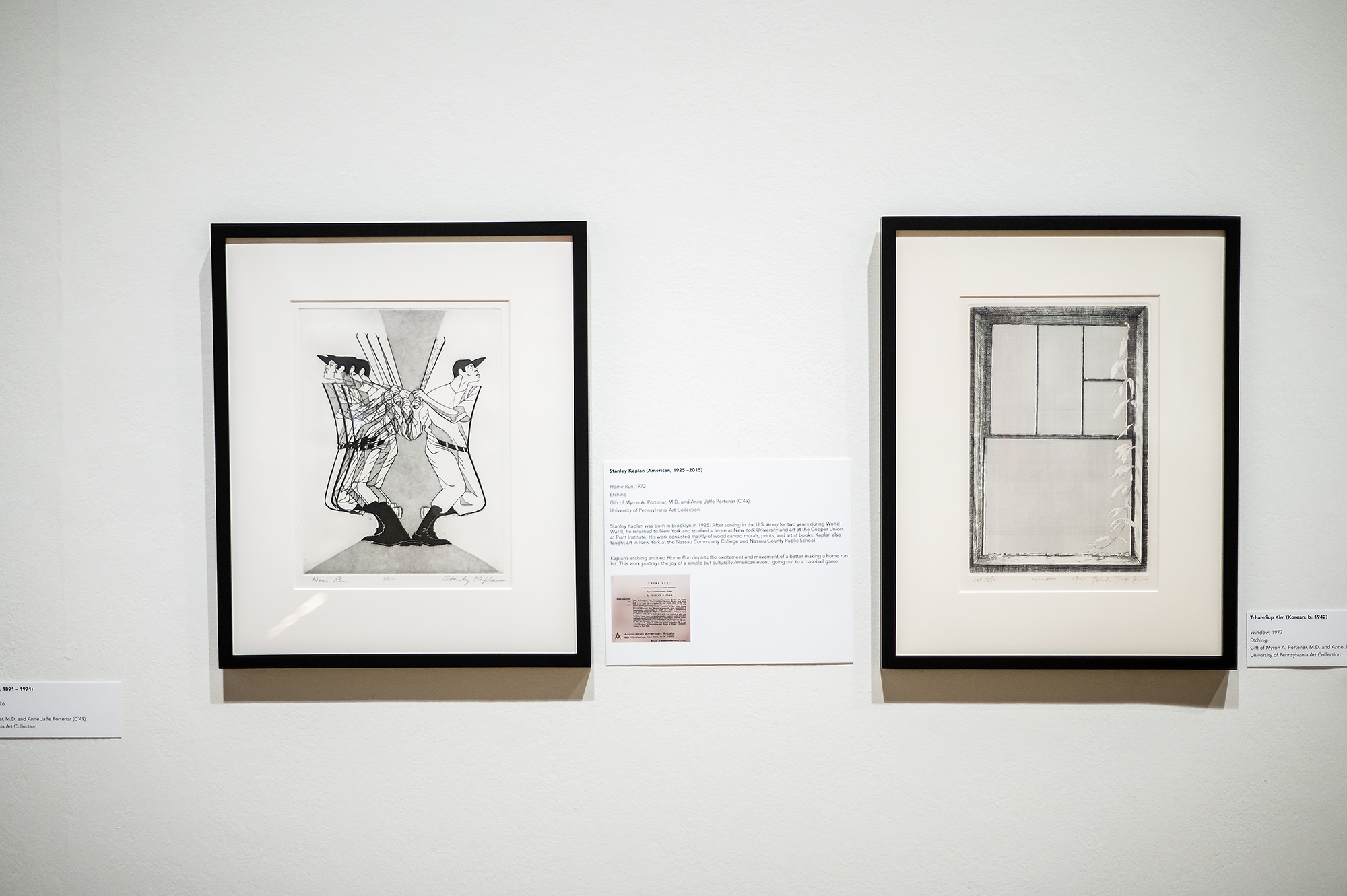 two prints on the gallery wall, one of a baseball player swinging a bat and the other of a window