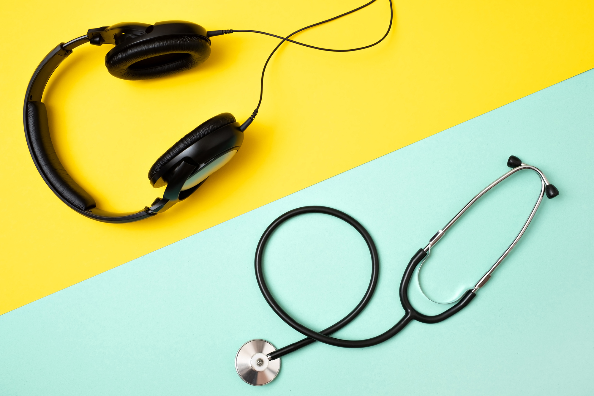 Headphones and a stethoscope on a table.