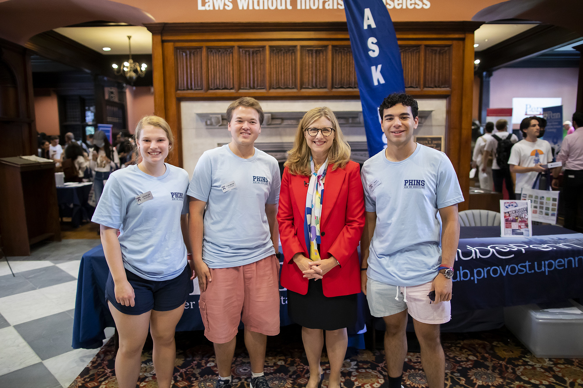 Penn President Liz Magill stands in Houston Hall with members of PHINS.