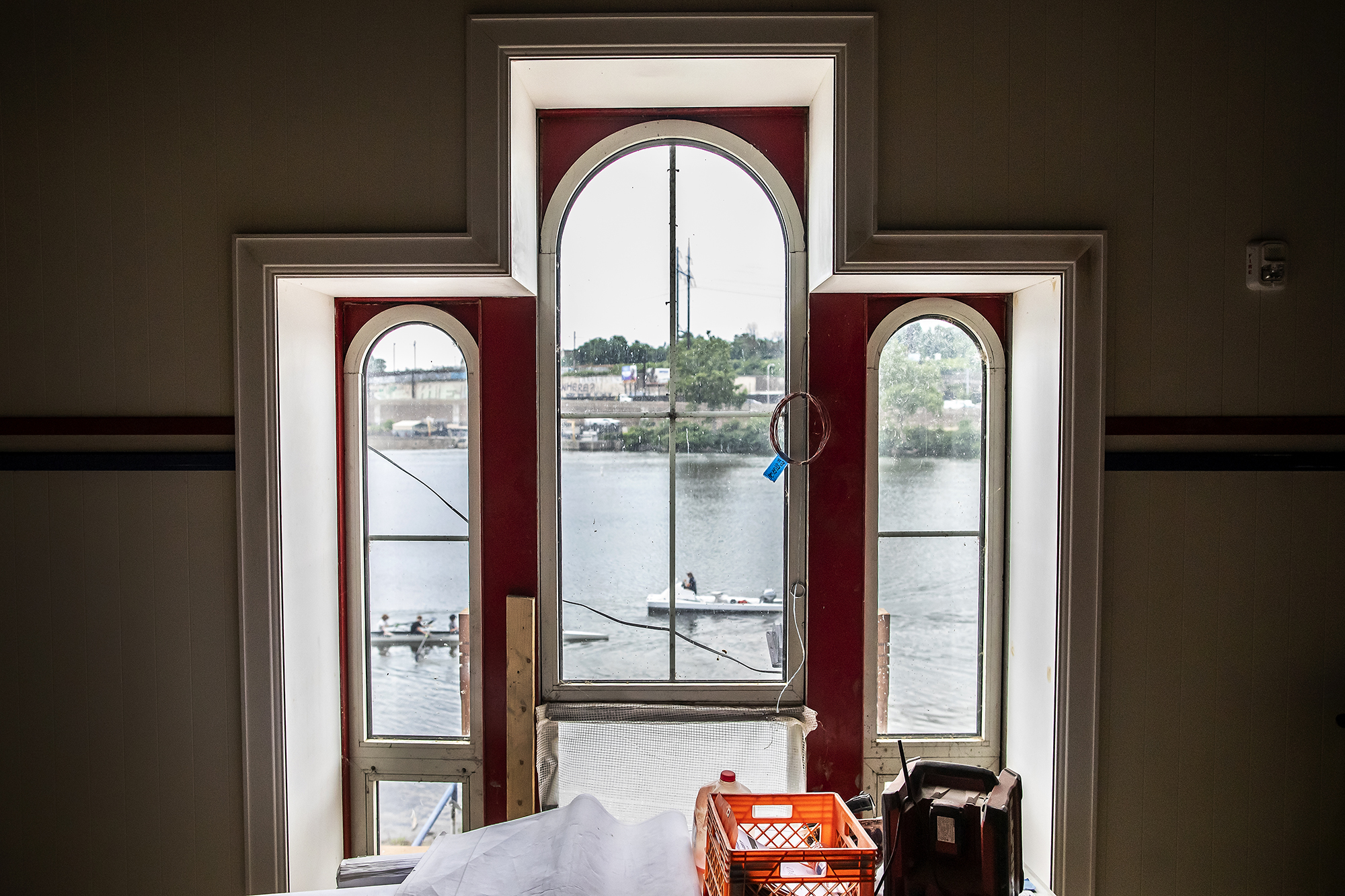 View of the Schuykill River through windows in the Penn Boathouse.