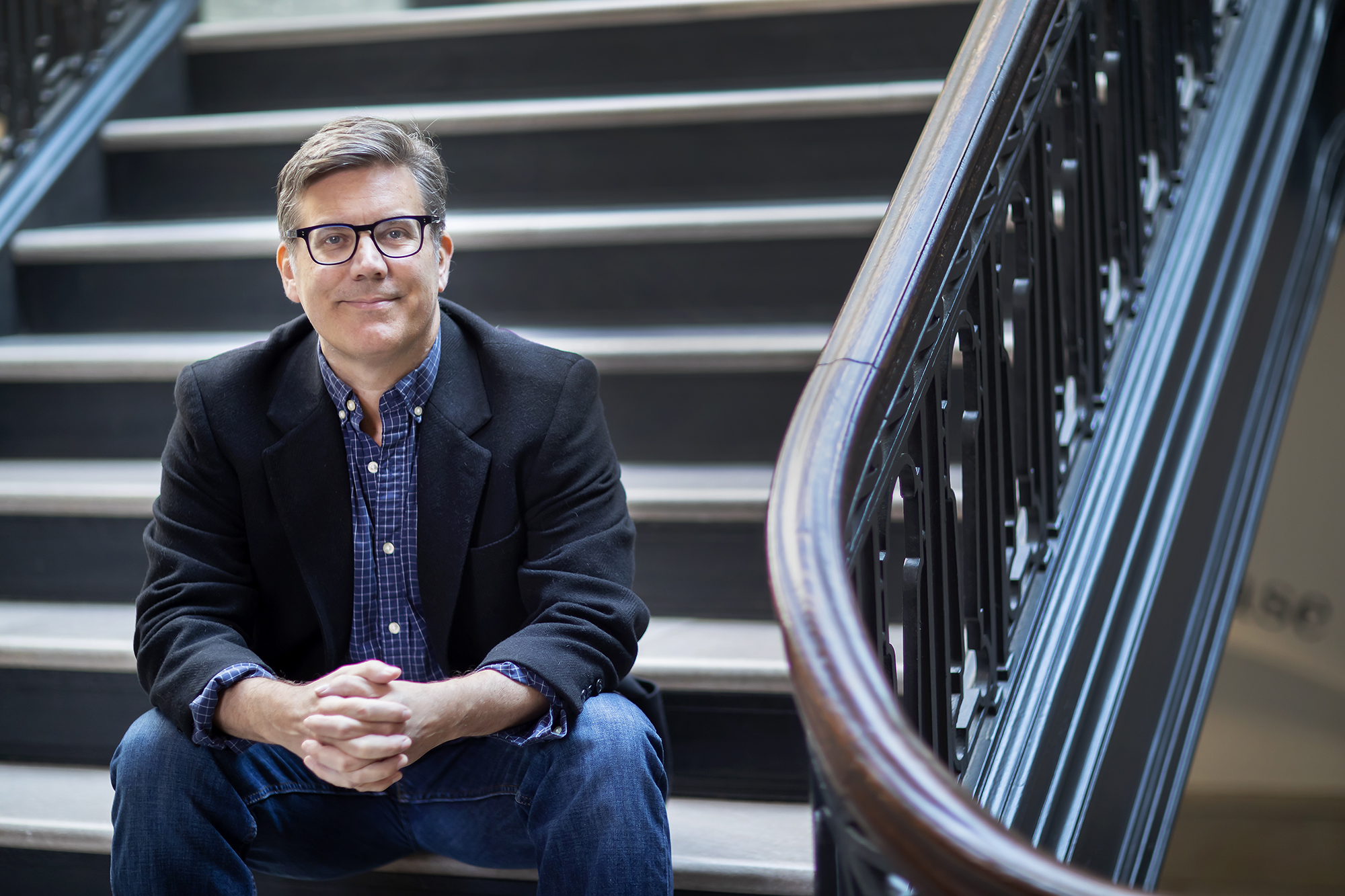 Jed Esty sitting on a staircase