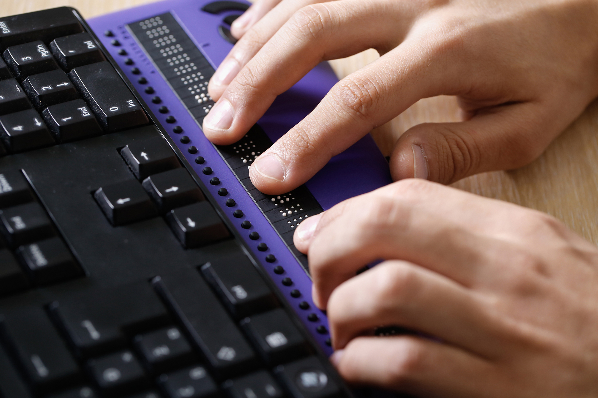 Hands typing on a keyboard.