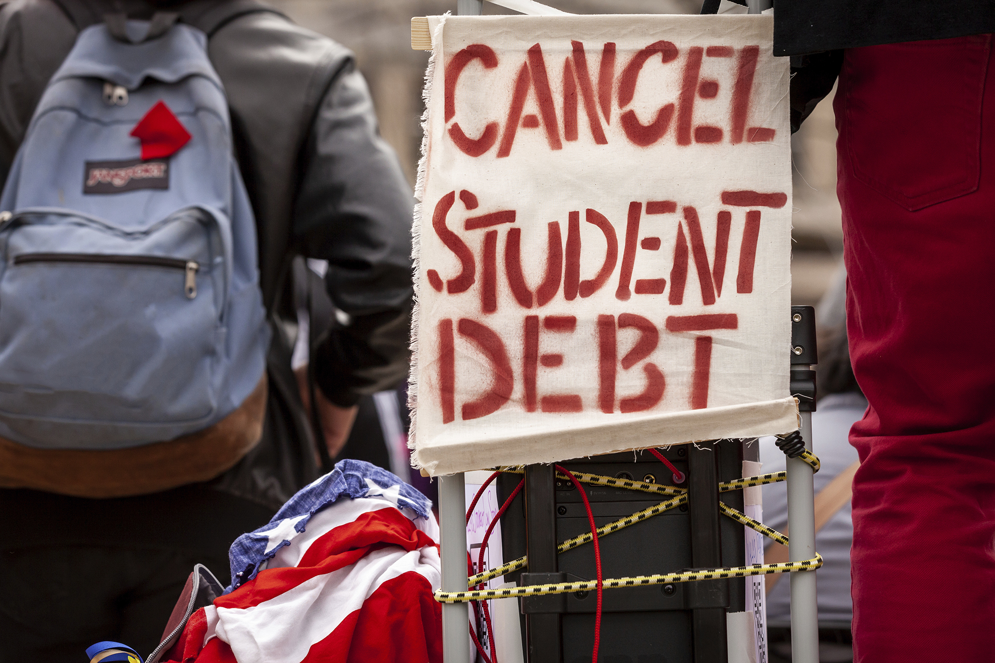 A sign calls for the cancellation of student debt at a rally.