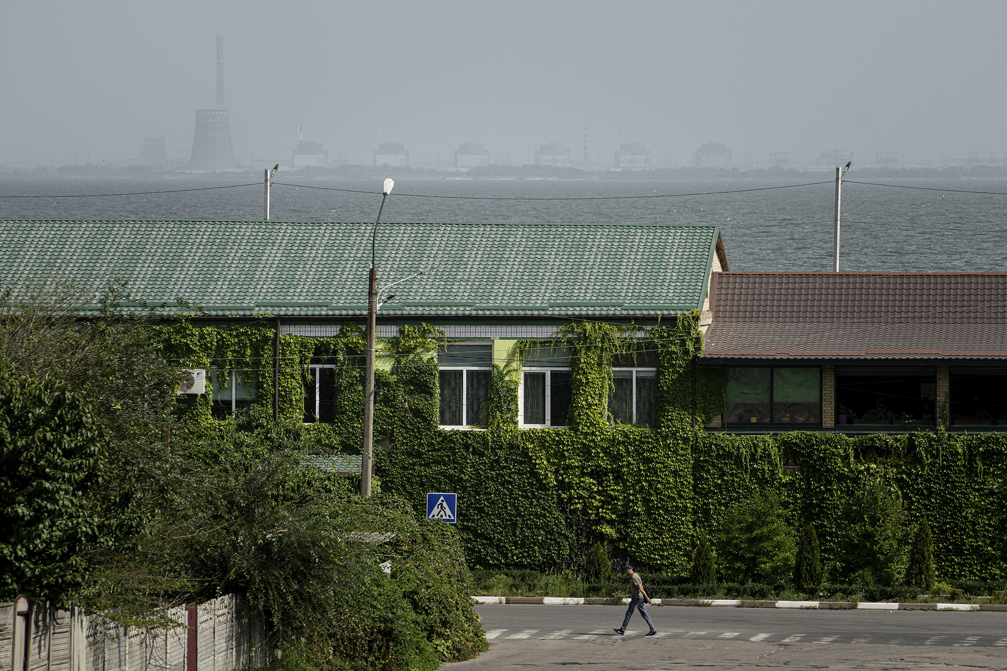 Person seen walking in a town across the river from the Zaporizhzhia Nuclear Power Plant in Ukraine