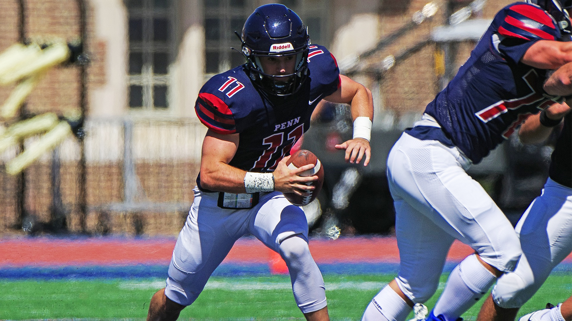 Fourth-year quarterback Andrew Paolini tucks the ball and prepares to run.