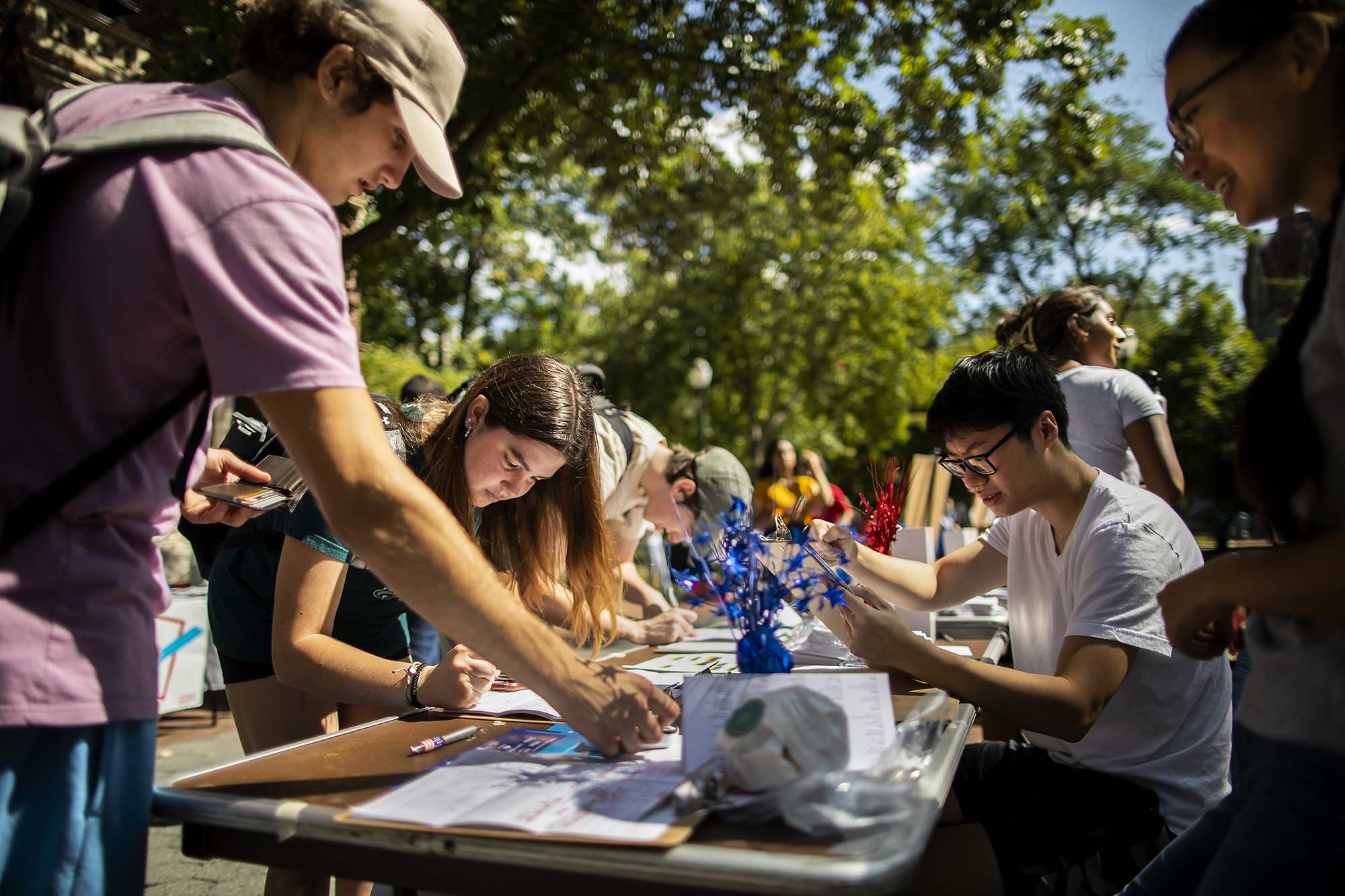 Members of Penn Leads the Vote register students to vote at tables on Locust Walk.