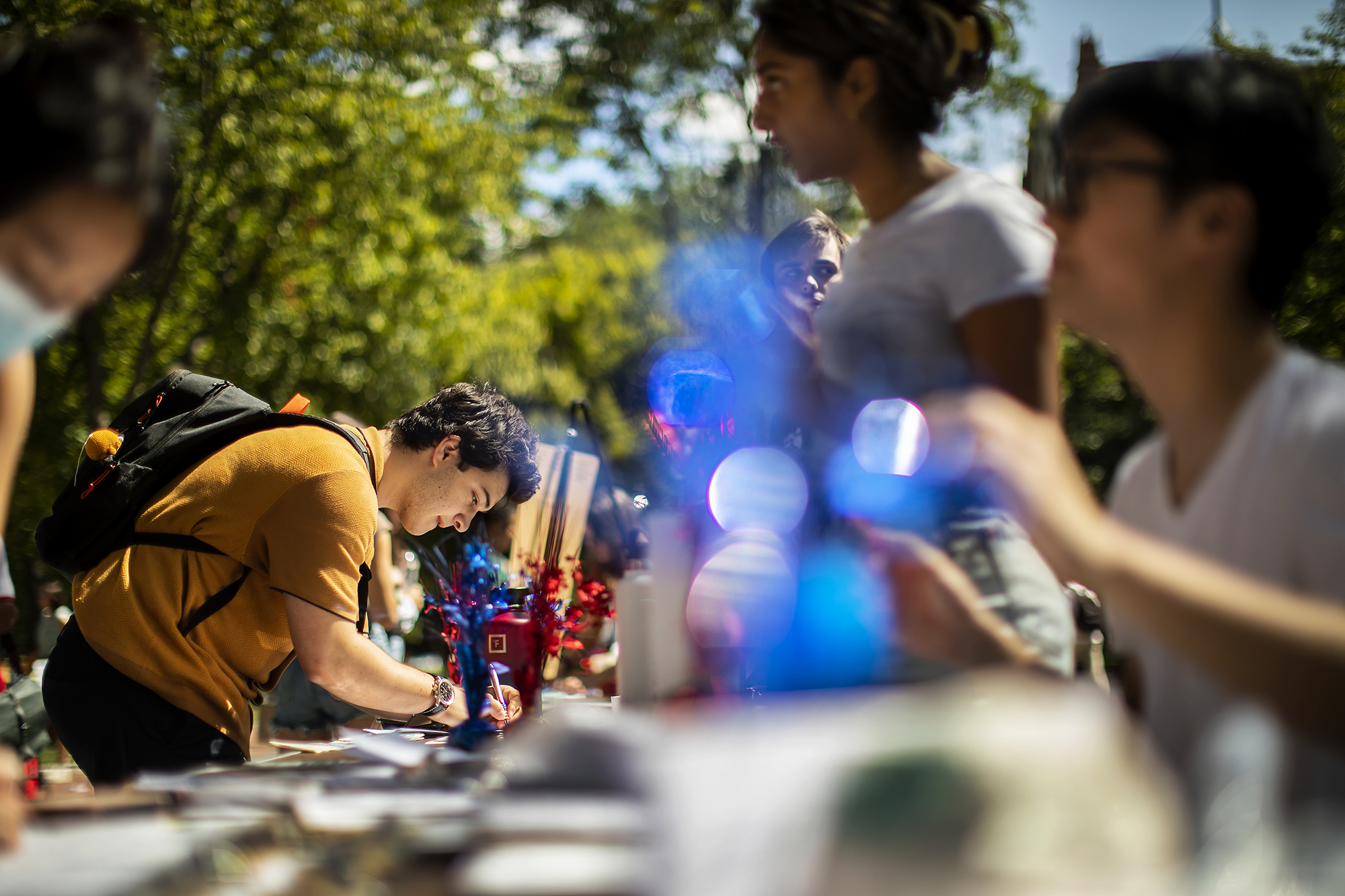 Students registering to vote on College Green at a Penn Leads the Vote voter registration drive.