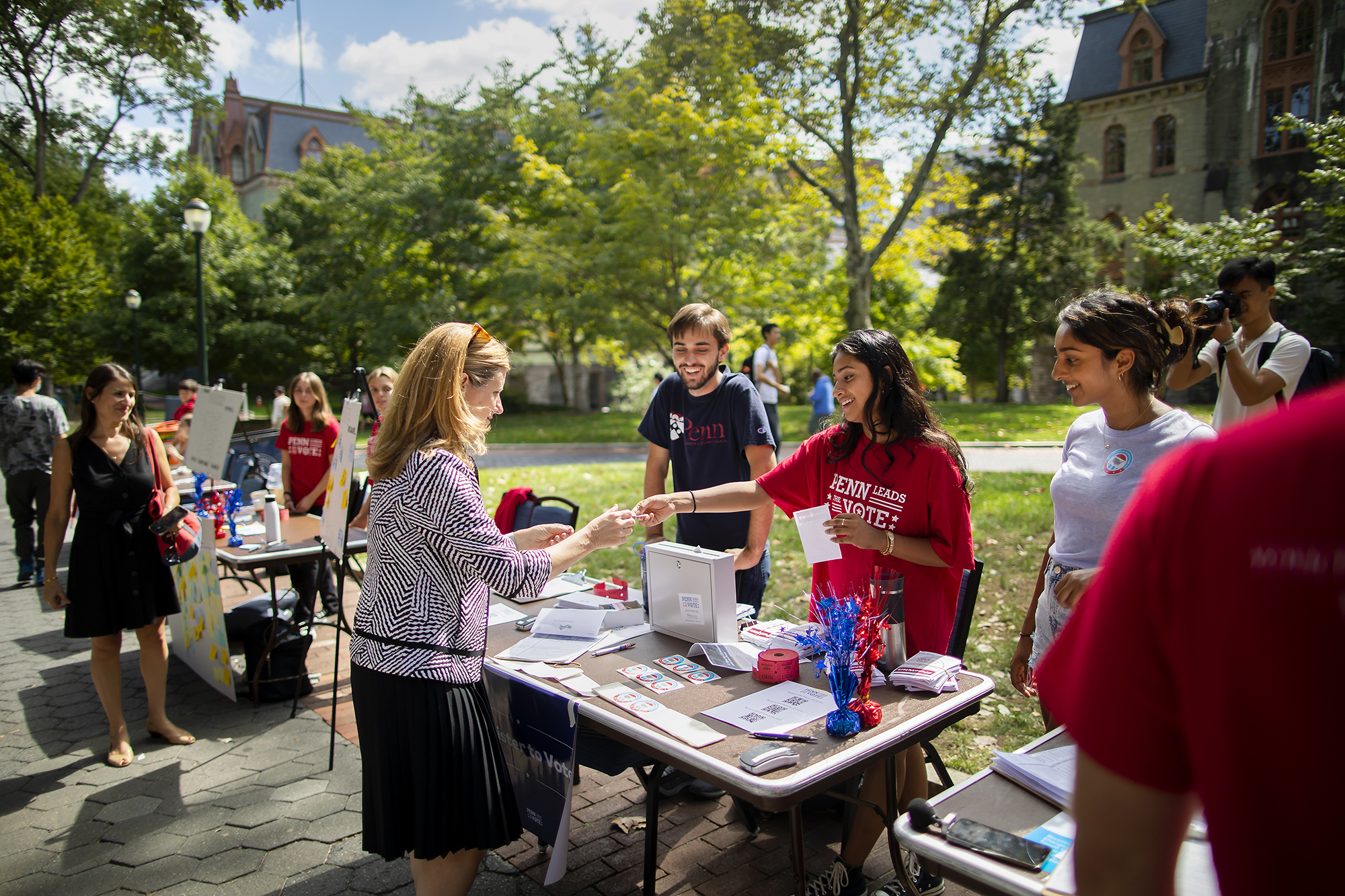 Penn President Liz Magill visits a Penn Leads the Vote table on College Green.