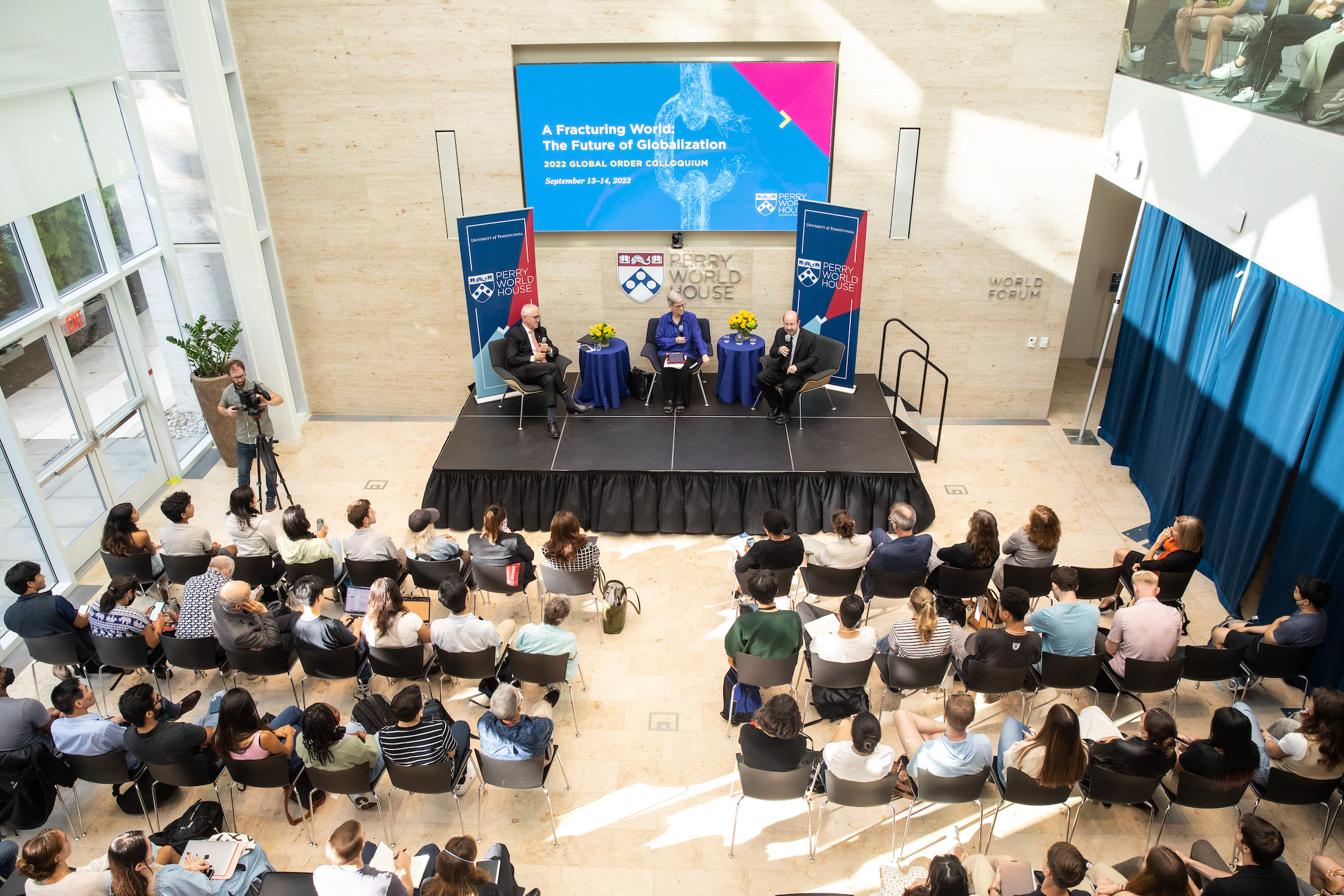 Former Australian Prime Minister Malcolm Turnbull, Kathleen Hall Jamieson and Penn climate scientist Michael E. Mann sit on a stage at Perry World house in front of an audience of listeners