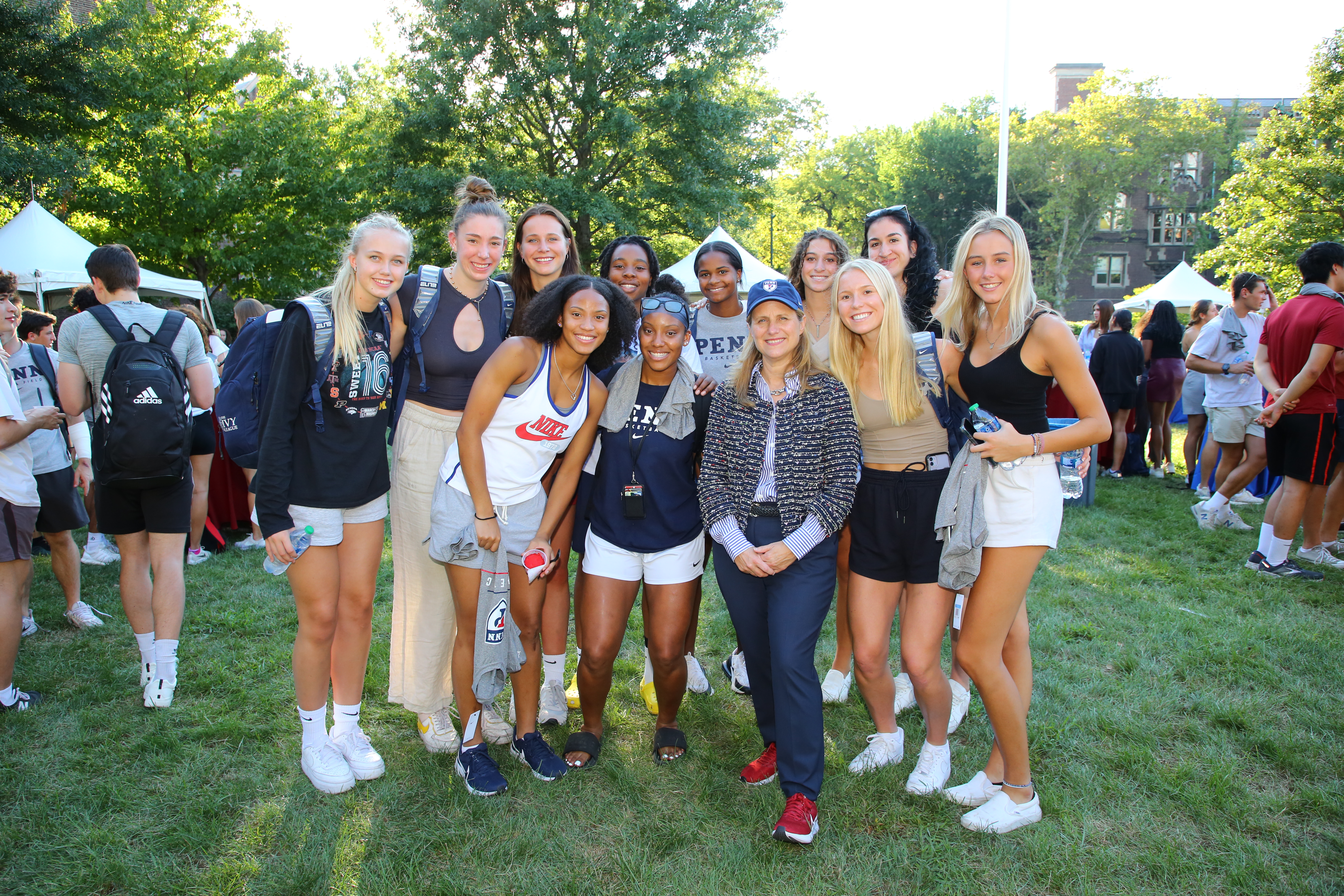 President Liz Magill poses with Penn student-athletes.