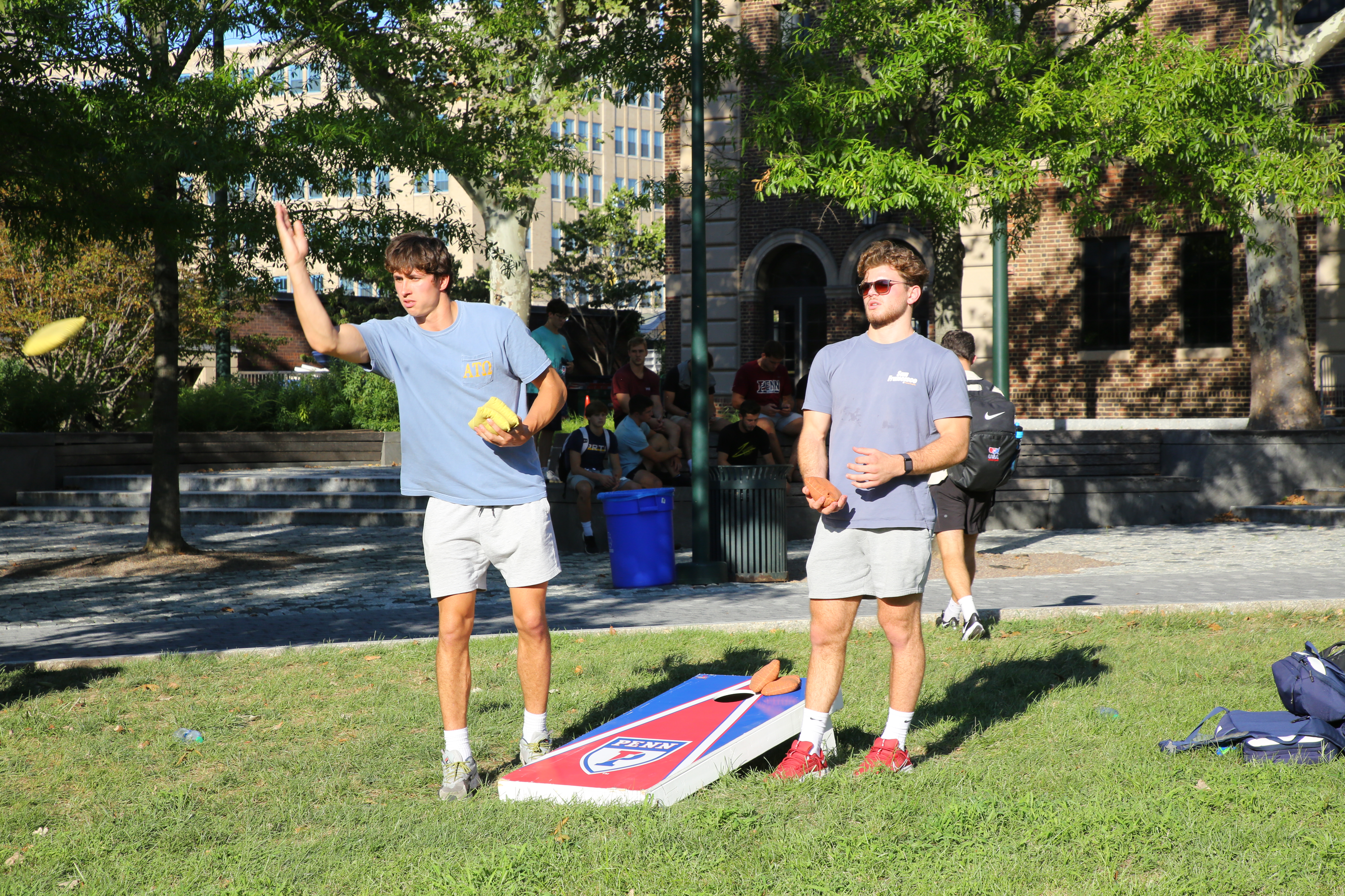 Two Penn students play cornhole.