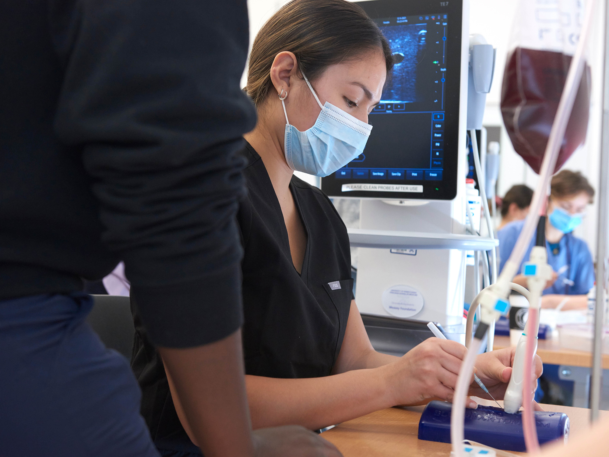 a penn med ultrasound tech practicing in a lab