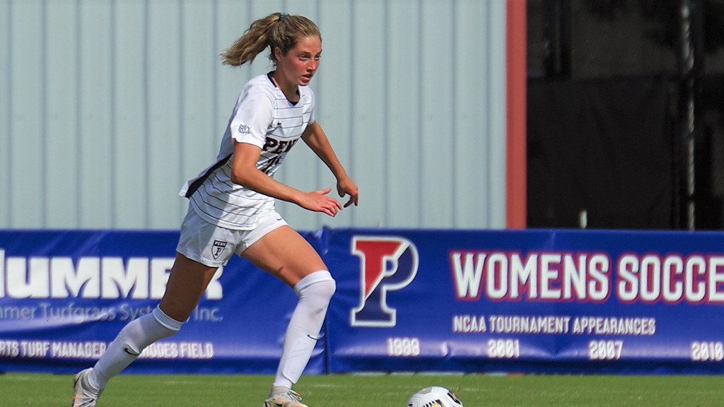 Senior midfielder Sara Readinger dribbles the ball up the field.