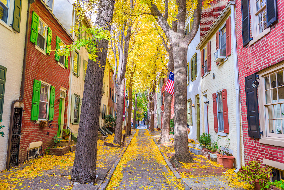 Alley street in historic Philadelphia shows trees with fall leaves