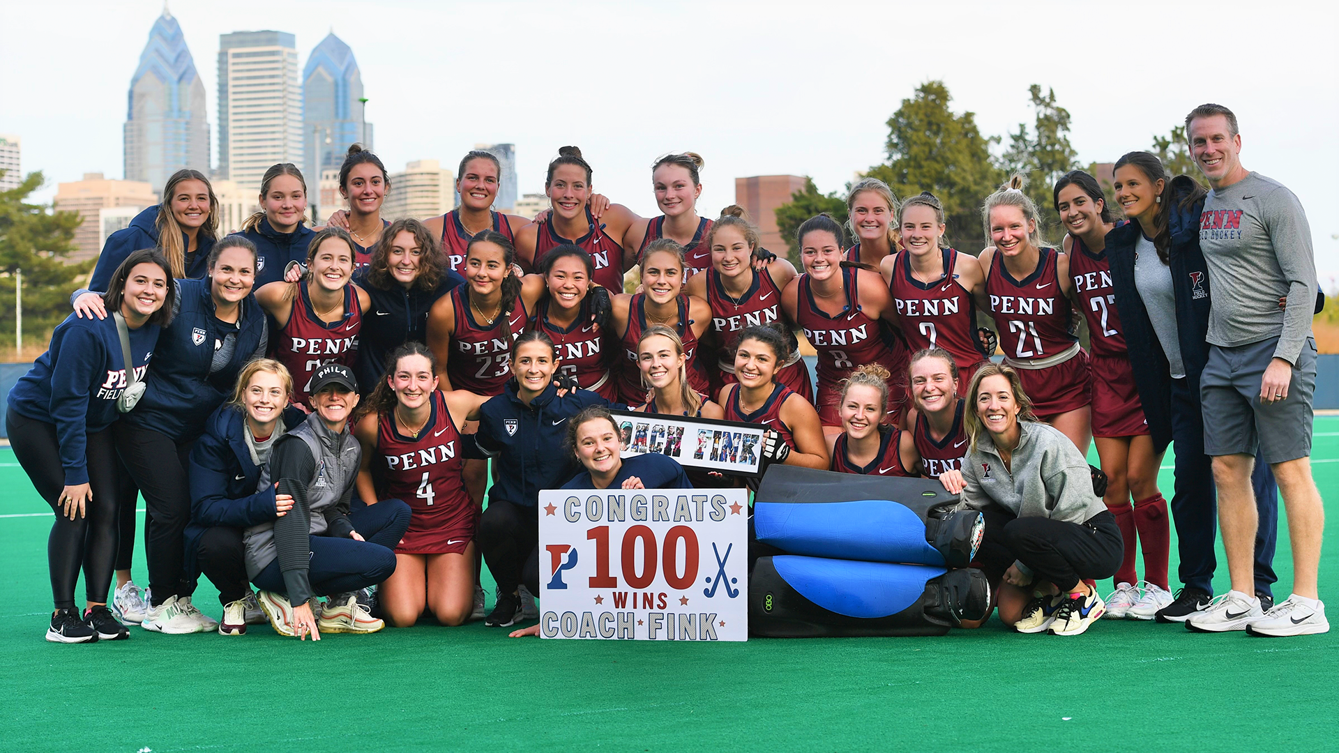 The field hockey team celebrates Head Coach Colleen Fink’s 100th win on Friday at Ellen Vagelos Field.