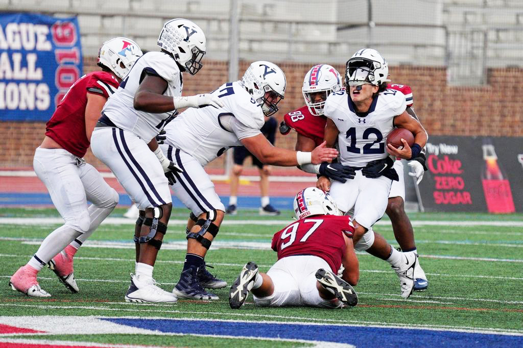 Third-year defensive lineman Joey Slackman (No. 97) helps bring down Yale quarterback Nolan Grooms during Penn’s 20-13 Homecoming win on Saturday at Franklin Field. 