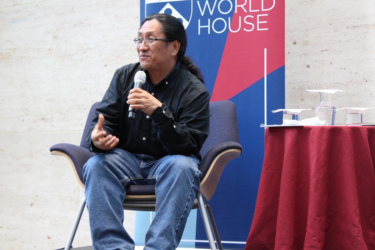 Maya activist Filiberto Penados speaks in a microphone on the Perry World House stage.