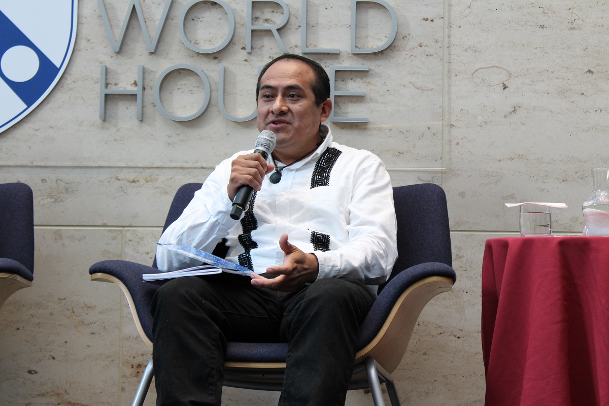 Maya activist Pablo Mis speaks in a microphone on the Perry World House stage.