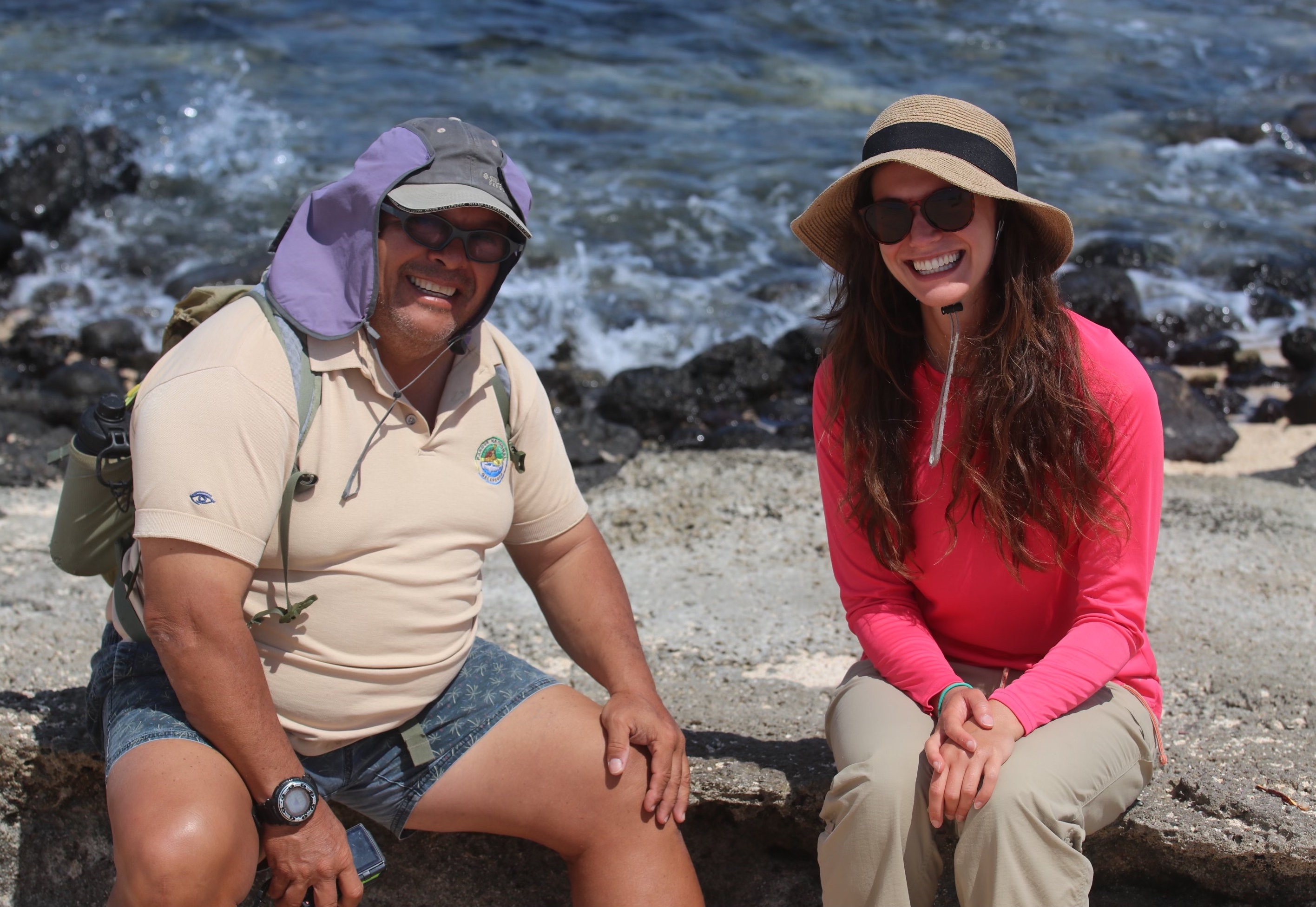 Ernesto Vaca and Victoria Moffit sit and smile by the water