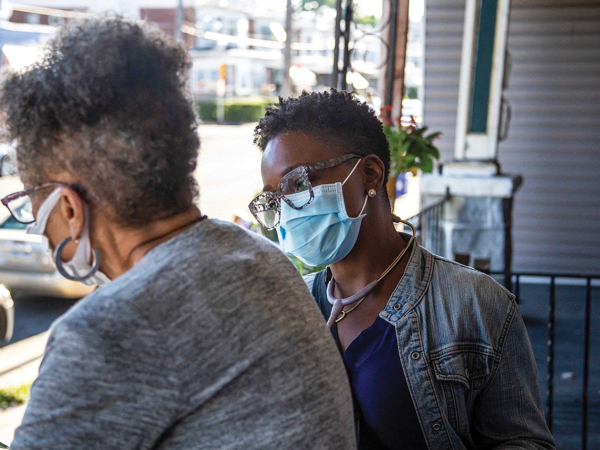 nurse speaking to patient outside on porch