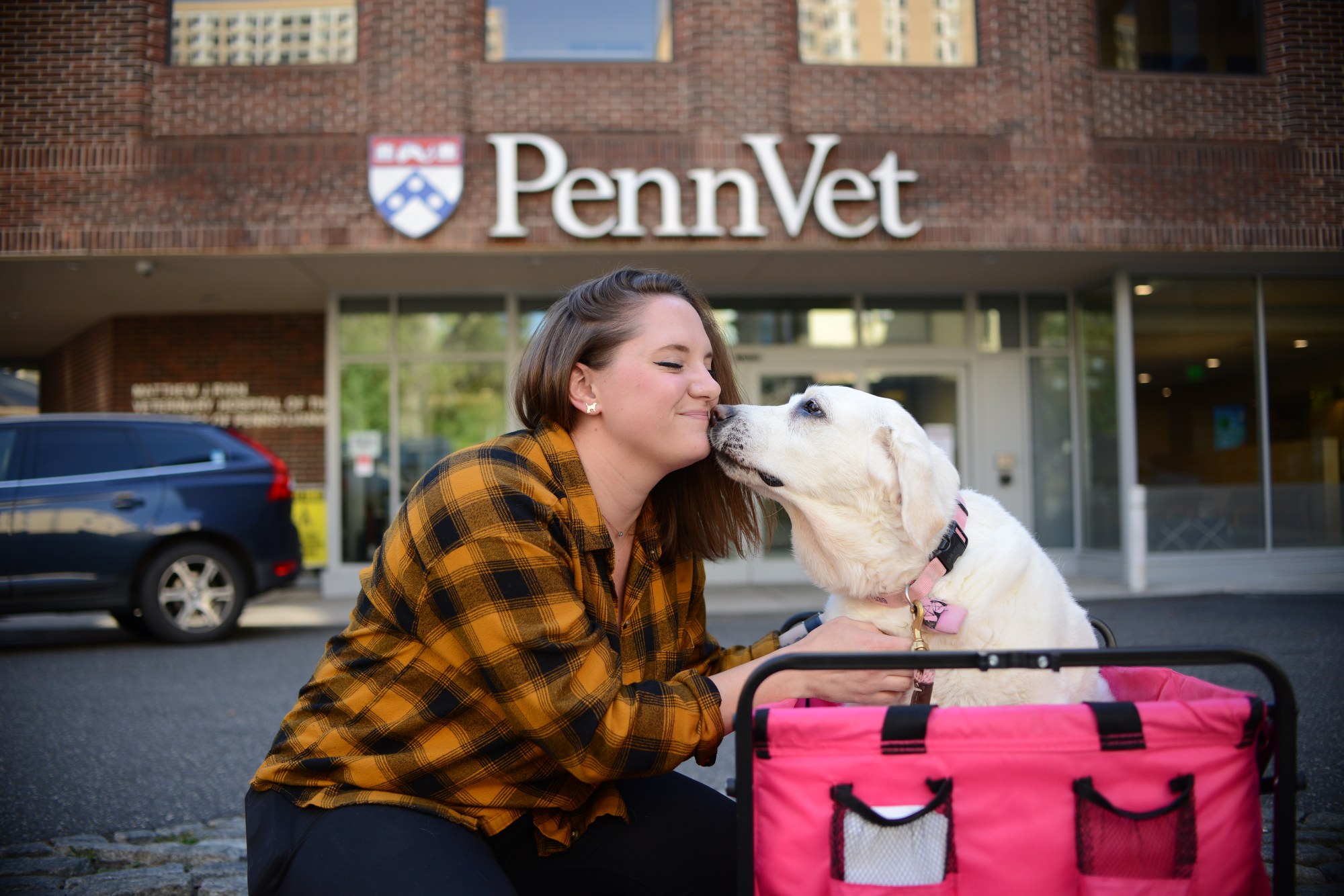 Meg Ruller with her dog Maple in front of Penn Vet