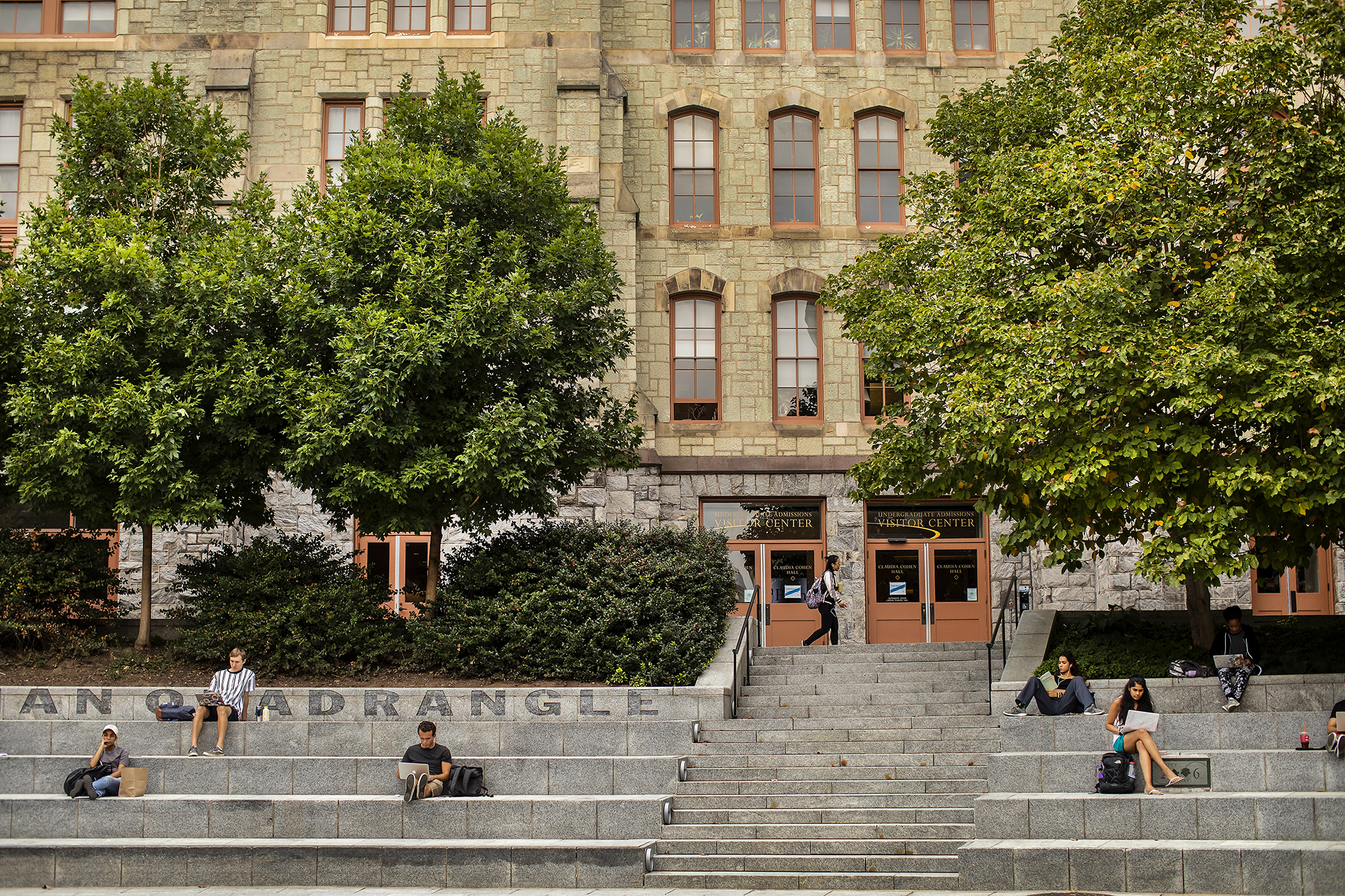 People sitting on the steps outside of the Perelman Quadrangle.