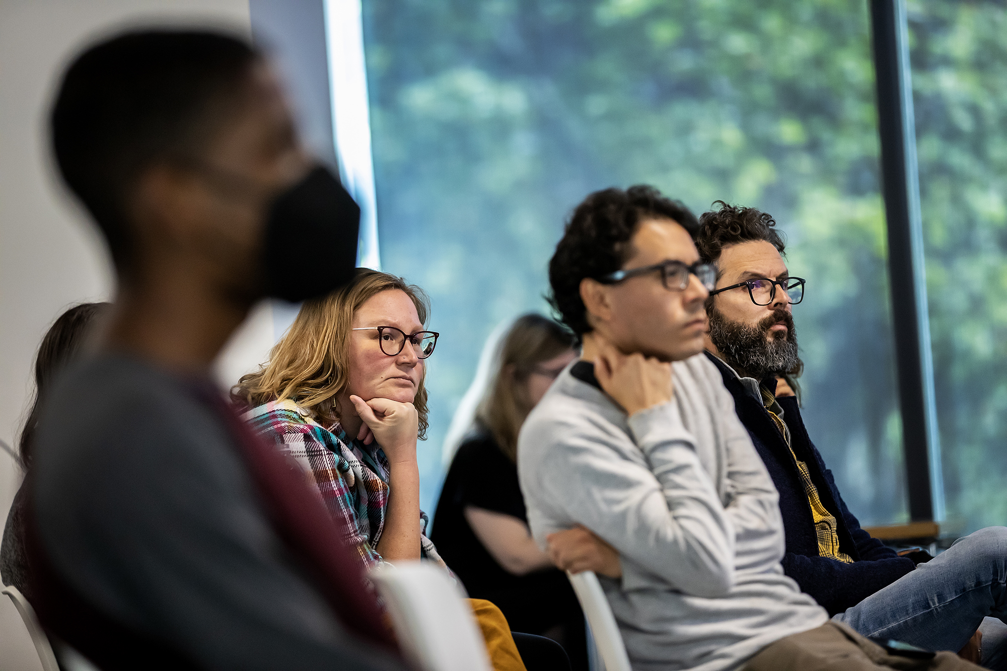 People seated listening to a speaker.