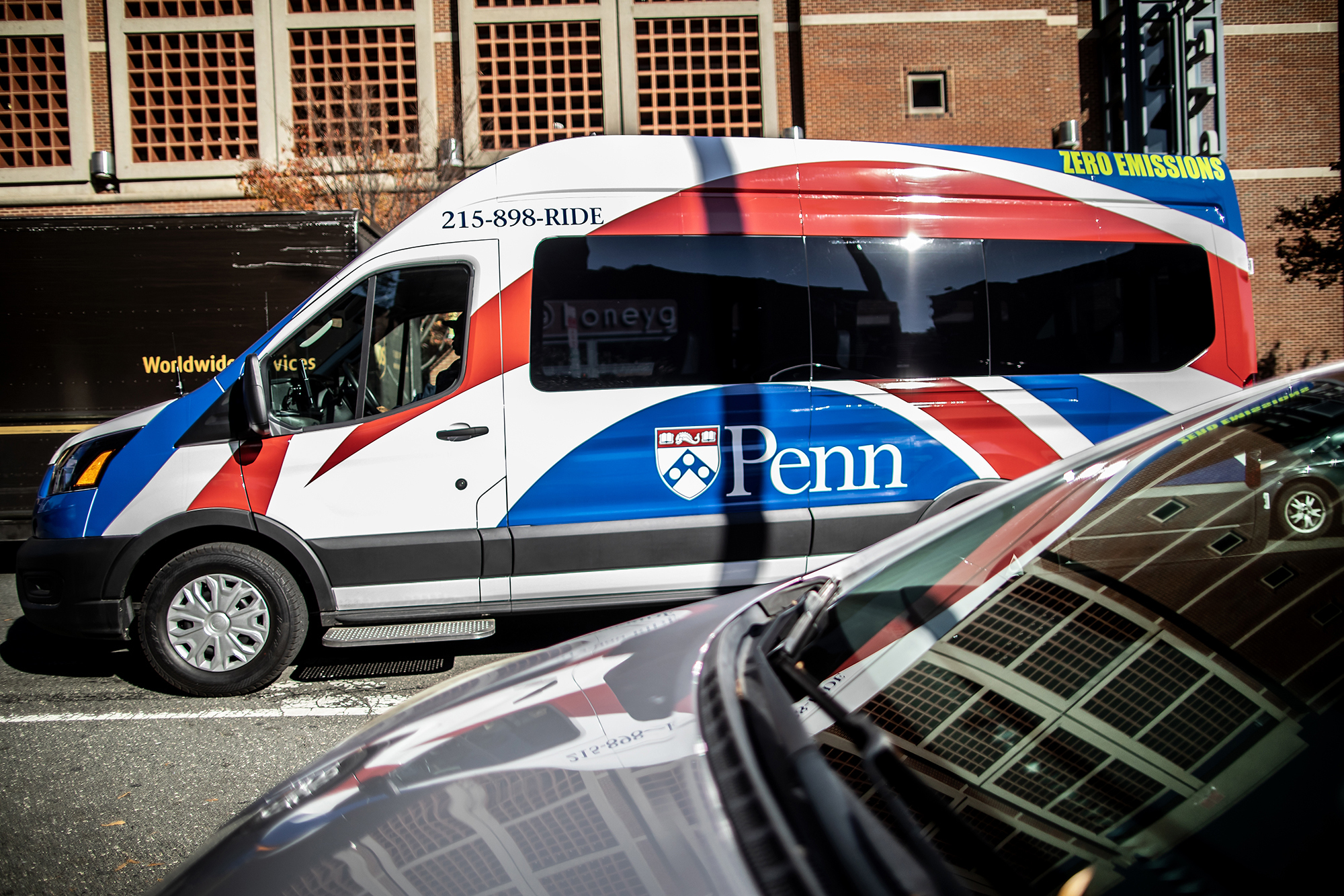 A van driving between two cars