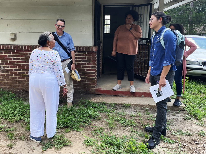 Weitzman’s Randall Mason (second from left) and Calvin Nguyen (second from right) visited Trinity Lutheran Parsonage with church member Willodean Malden (left) and Tiffani Simple stand outside the entrance of a building.