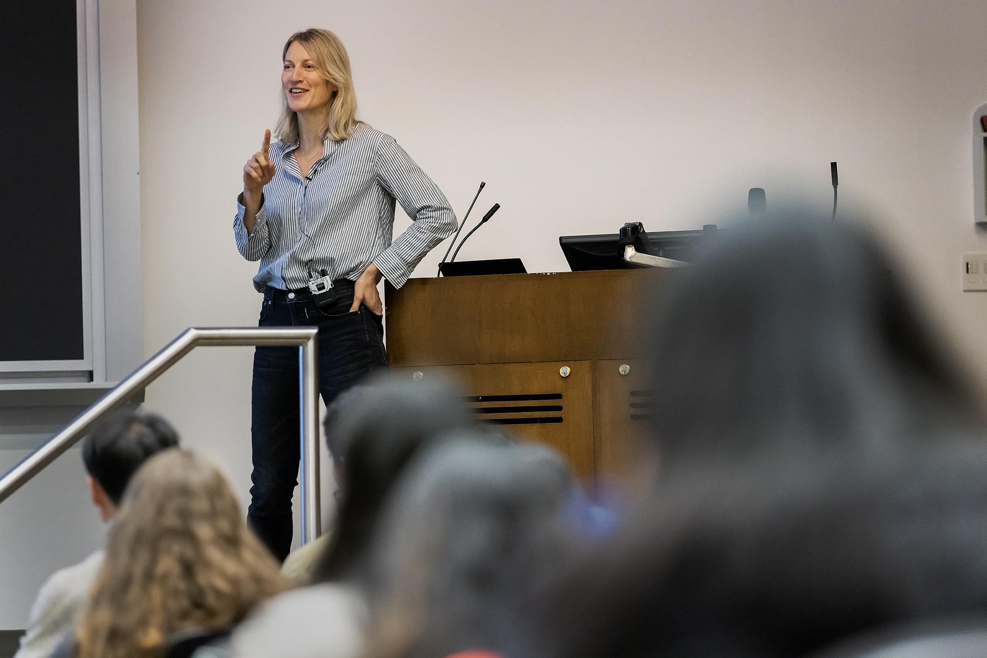 Professor Anne Duchene gestures in front of her microeconomics classes.