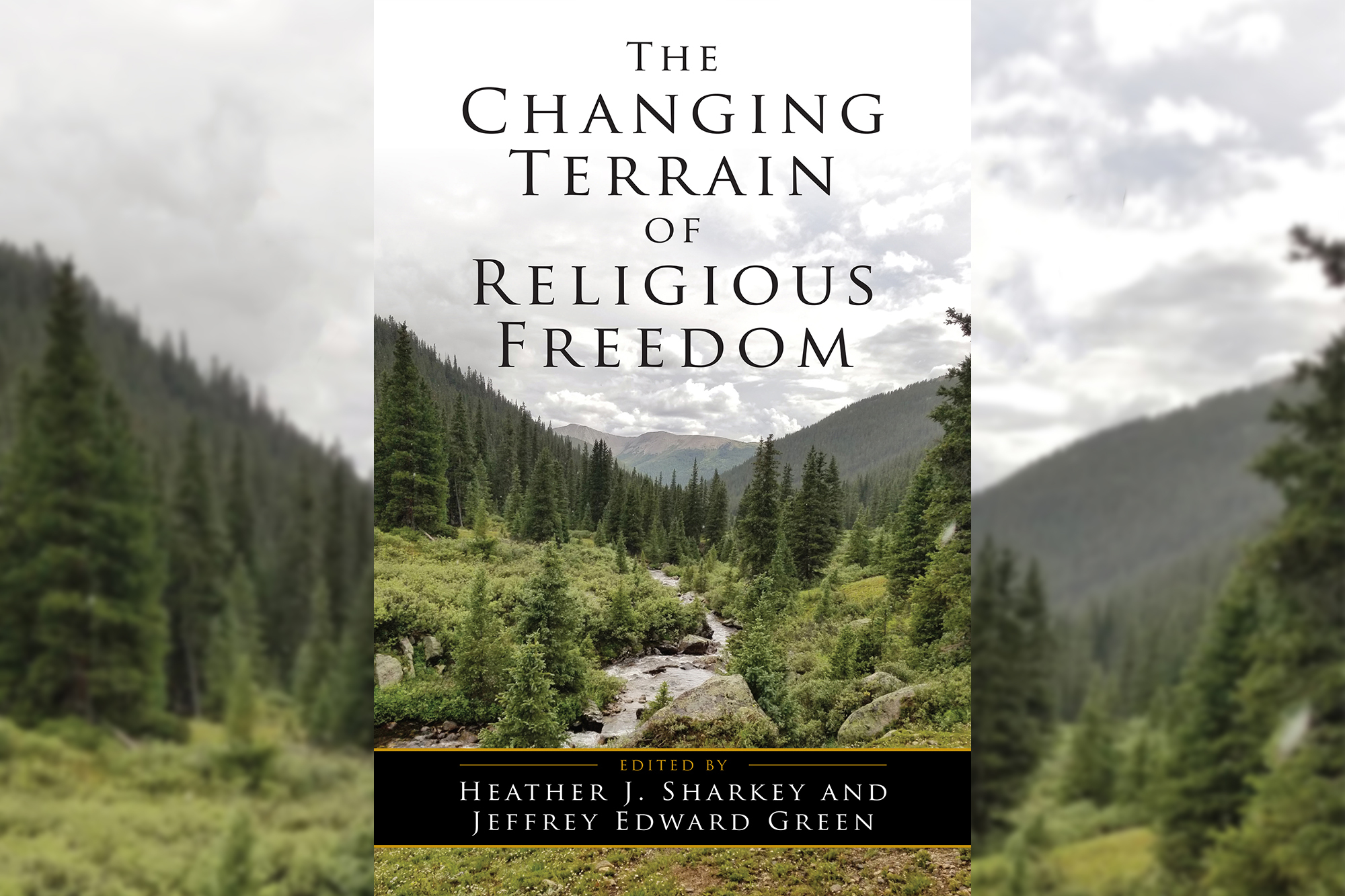 Cover for the jacket of book called "The Changing Terrain of Religious Freedom" shows a Colorado mountain scene with pines and a river with hills in the distance
