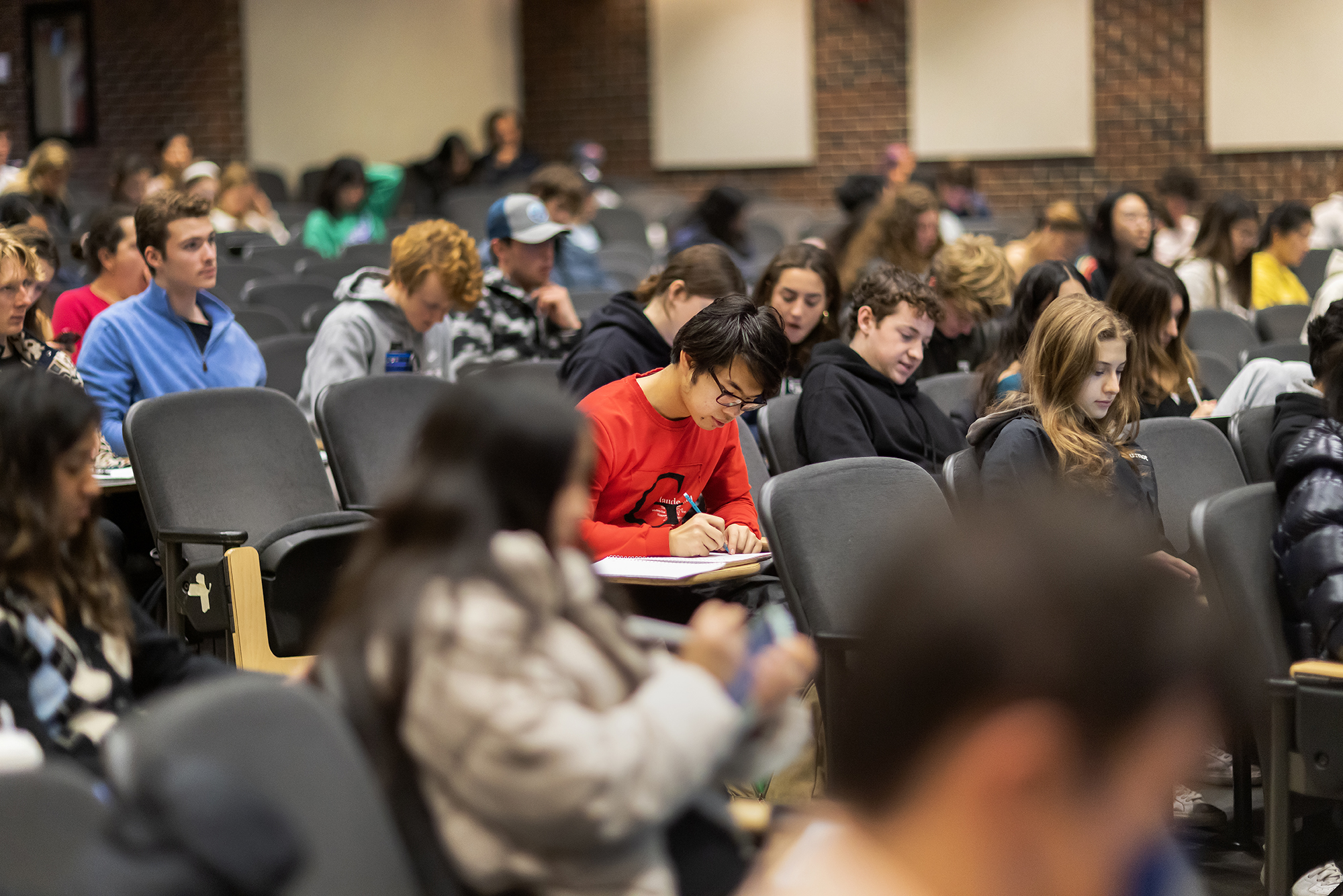 Students work in a lecture hall at Penn.