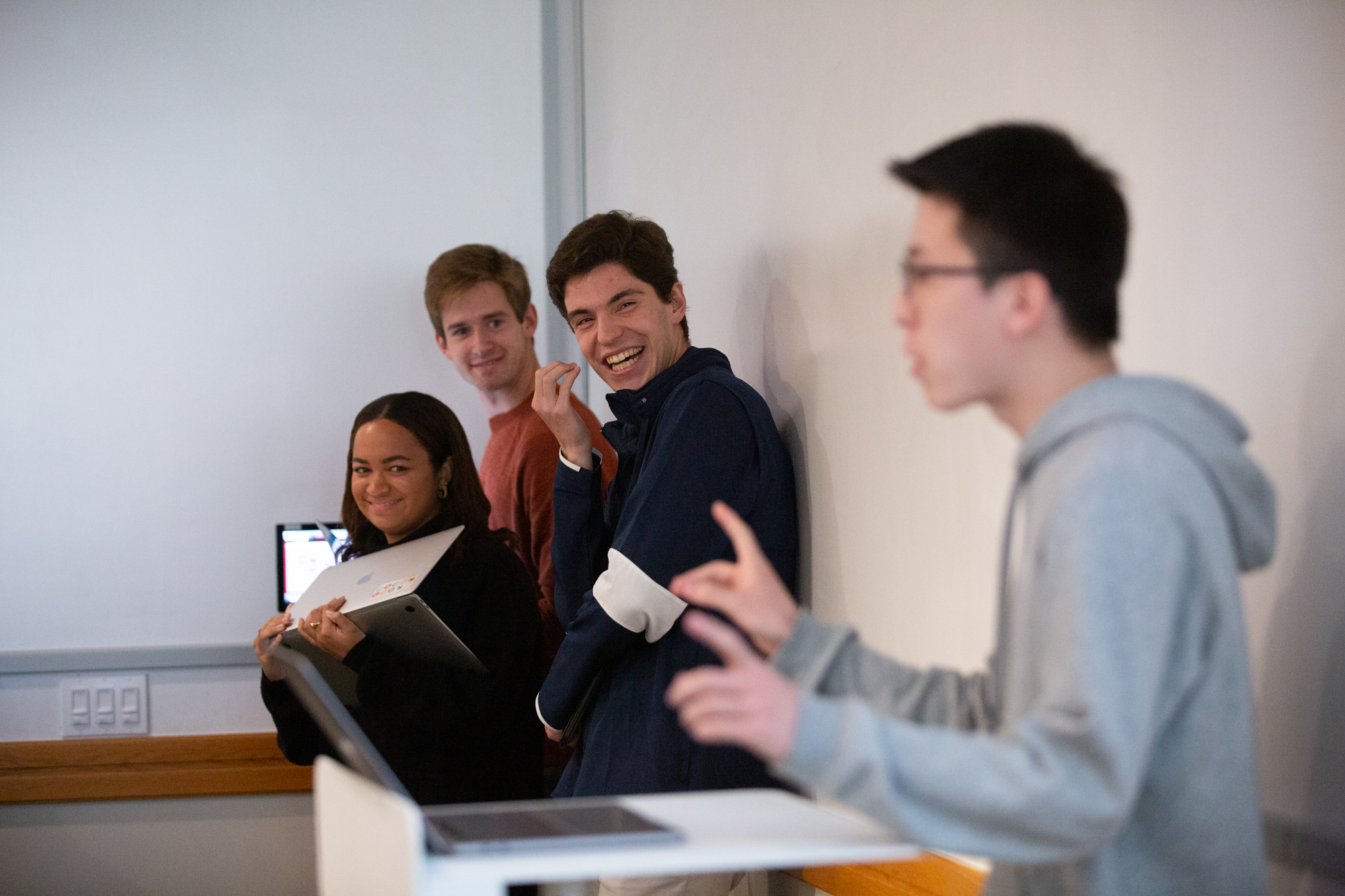 Debaters chuckle at a participant's comments at the podium during debates in the Future of Conservatism class.