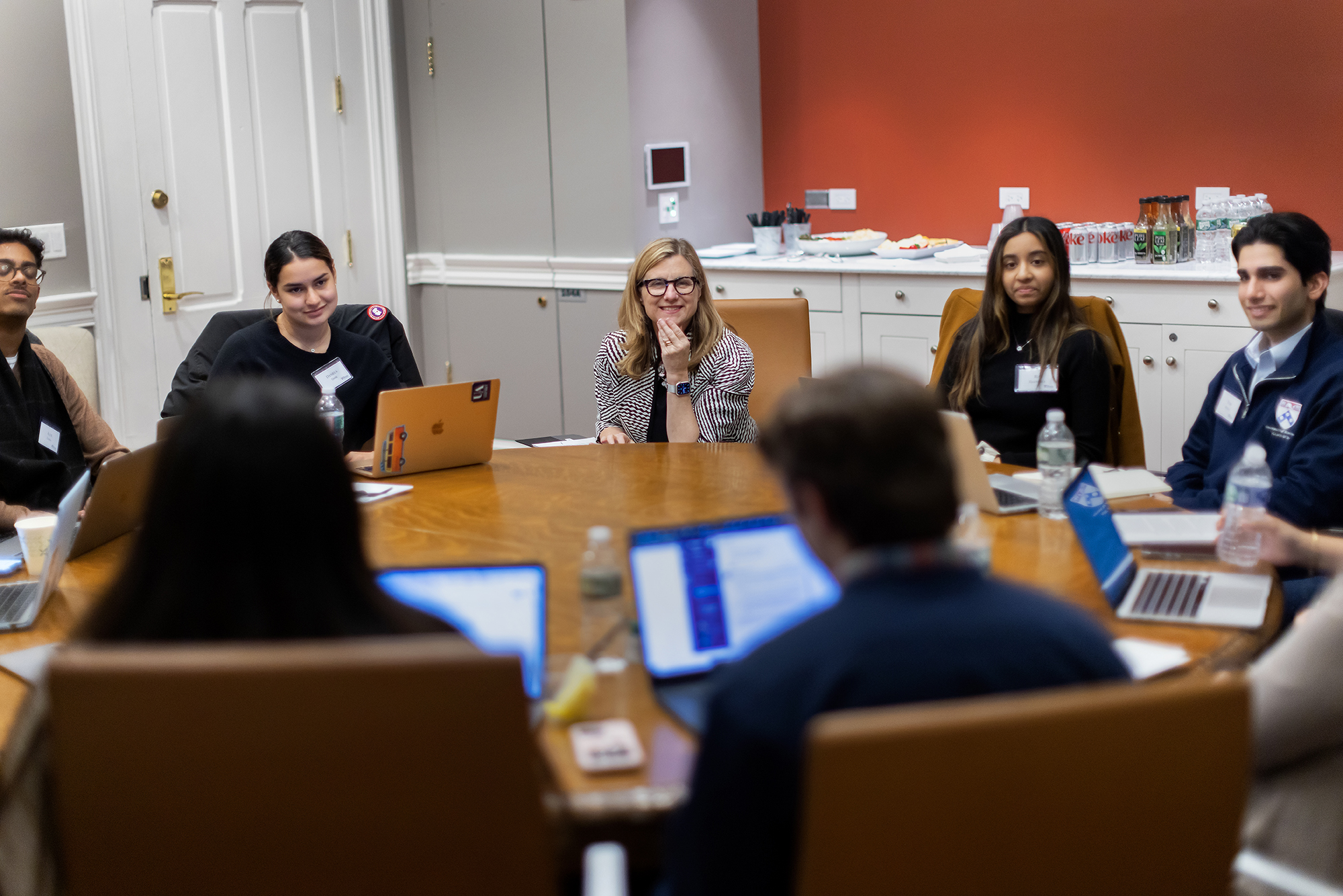 Liz Magill seated at a round table with others.