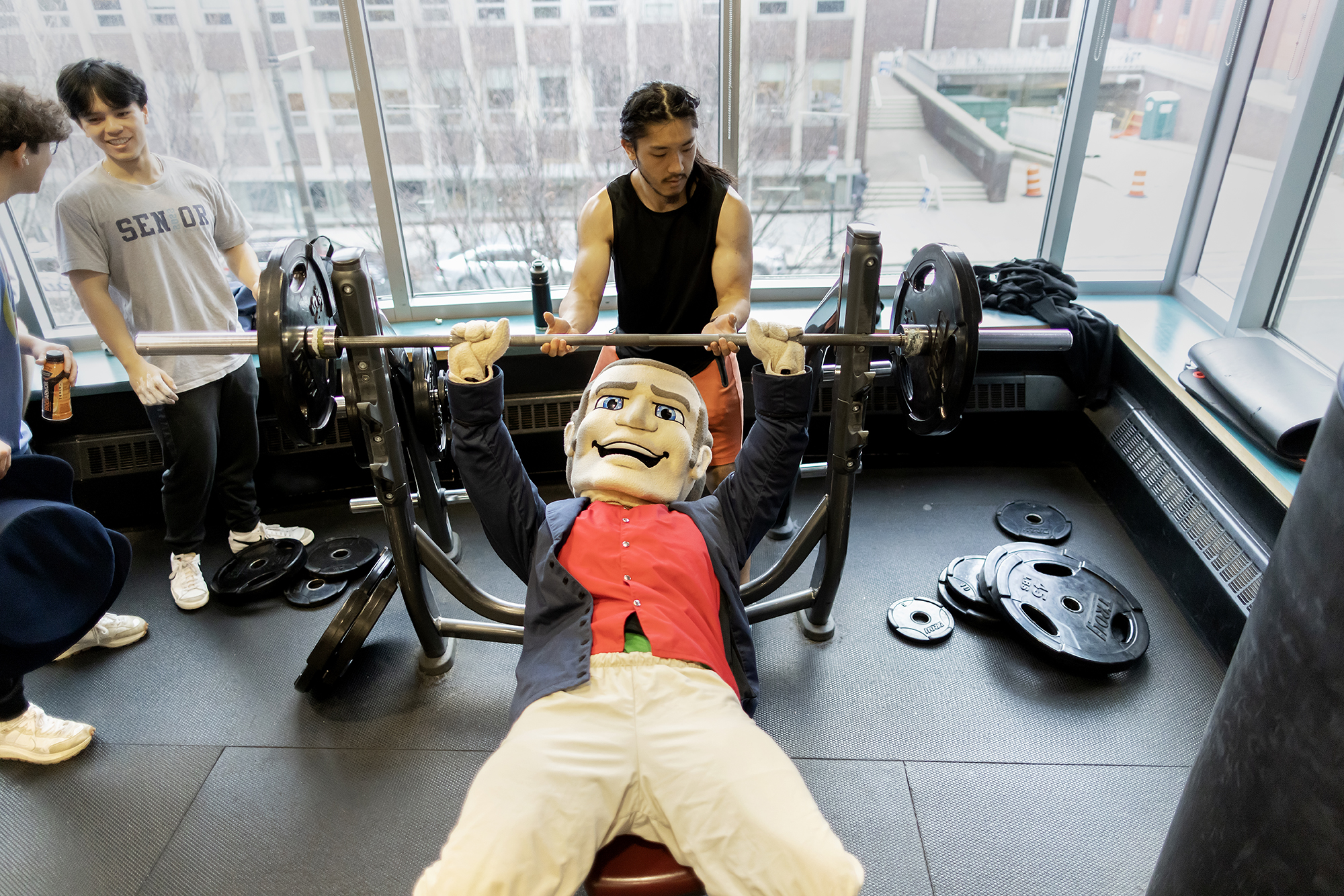 The Penn Quaker does a bench press in the second-floor weight room at the Pottruck Center during the birthday bash.