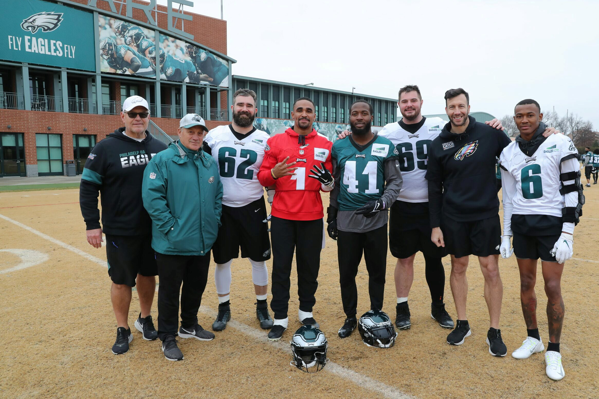 Connor Barwin (second from right) stands on the field with other members of the Eagles football team.