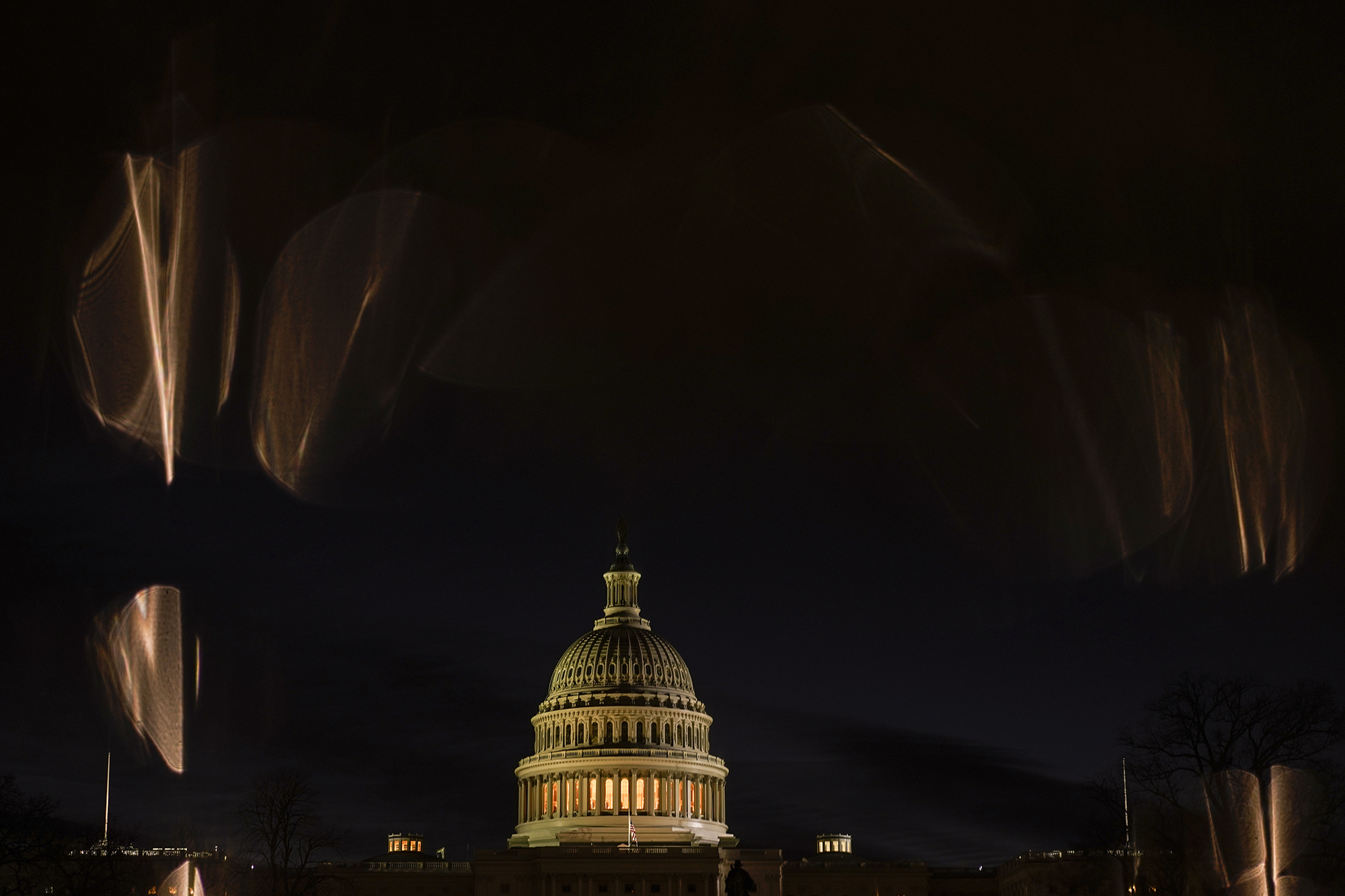 The U.S. Capitol is seen reflected in a puddle in Washington, just before sunrise, on Jan. 6, 2022, on the one year anniversary of the attack on the U.S. Capitol.