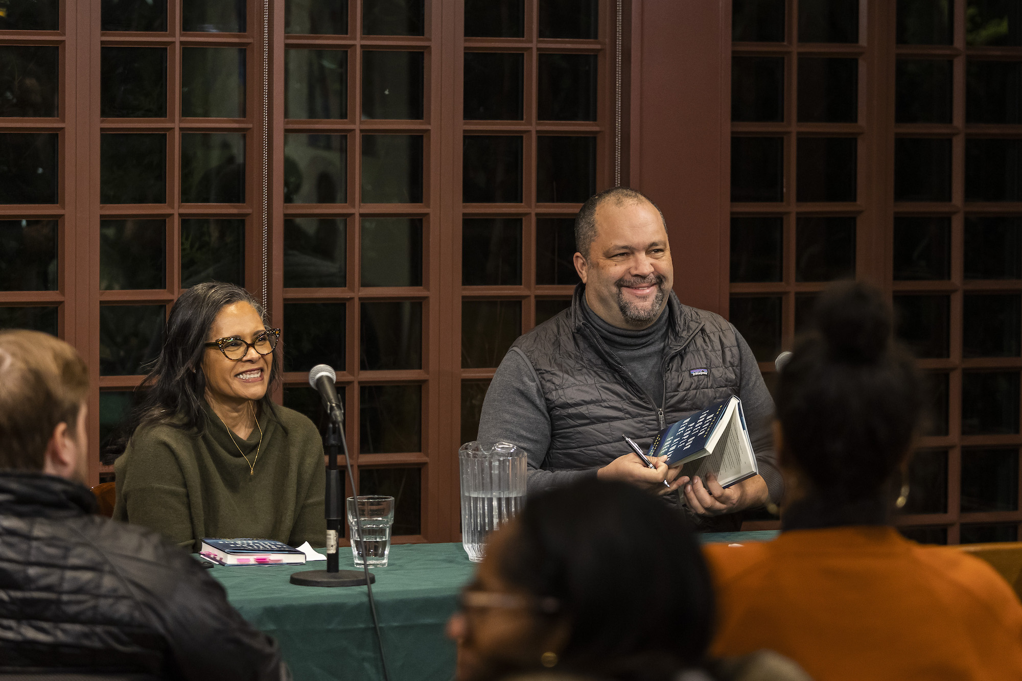 Camille Charles and Ben Jealous smile at the audience at a Kelly Writers House event.