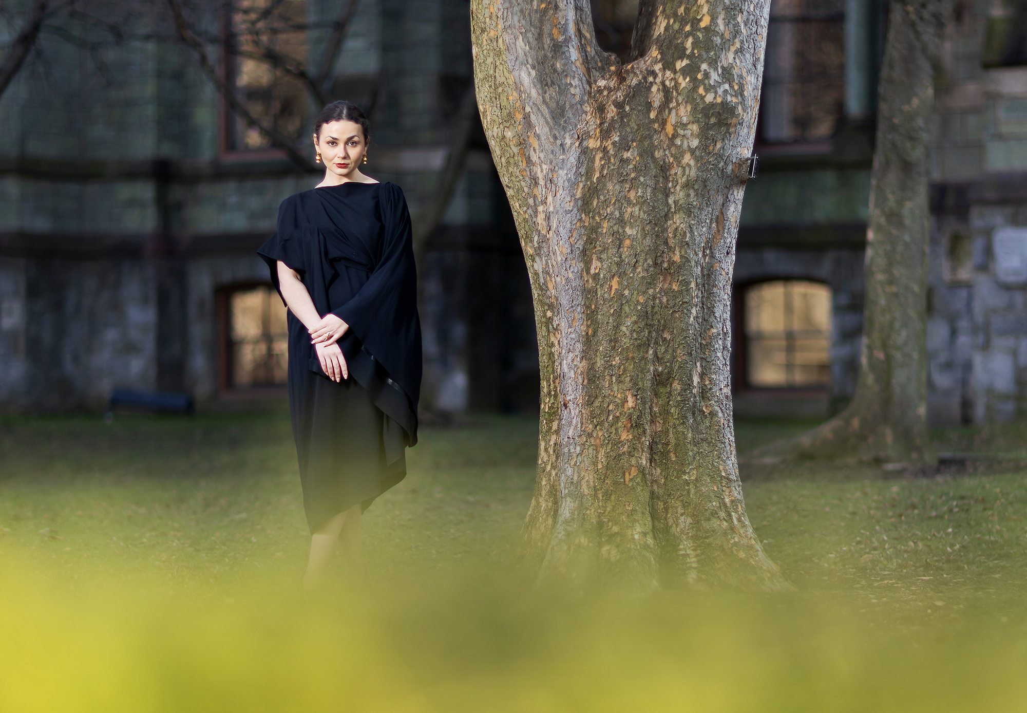 Hannah Kaluher stands near a tree in front of College Hall on Penn campus.