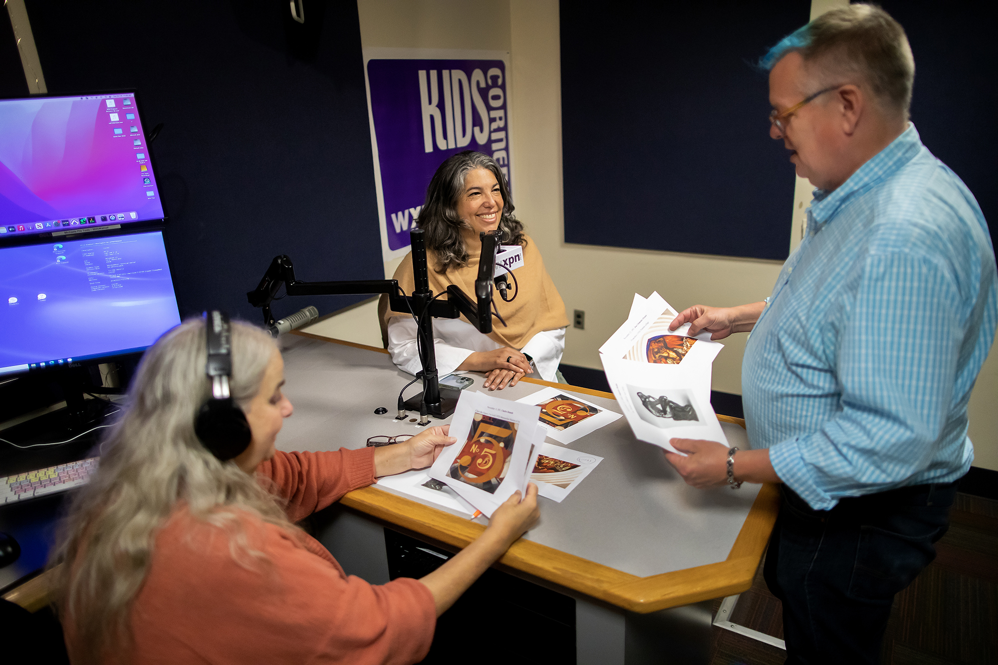 Three people in a radio recording studio