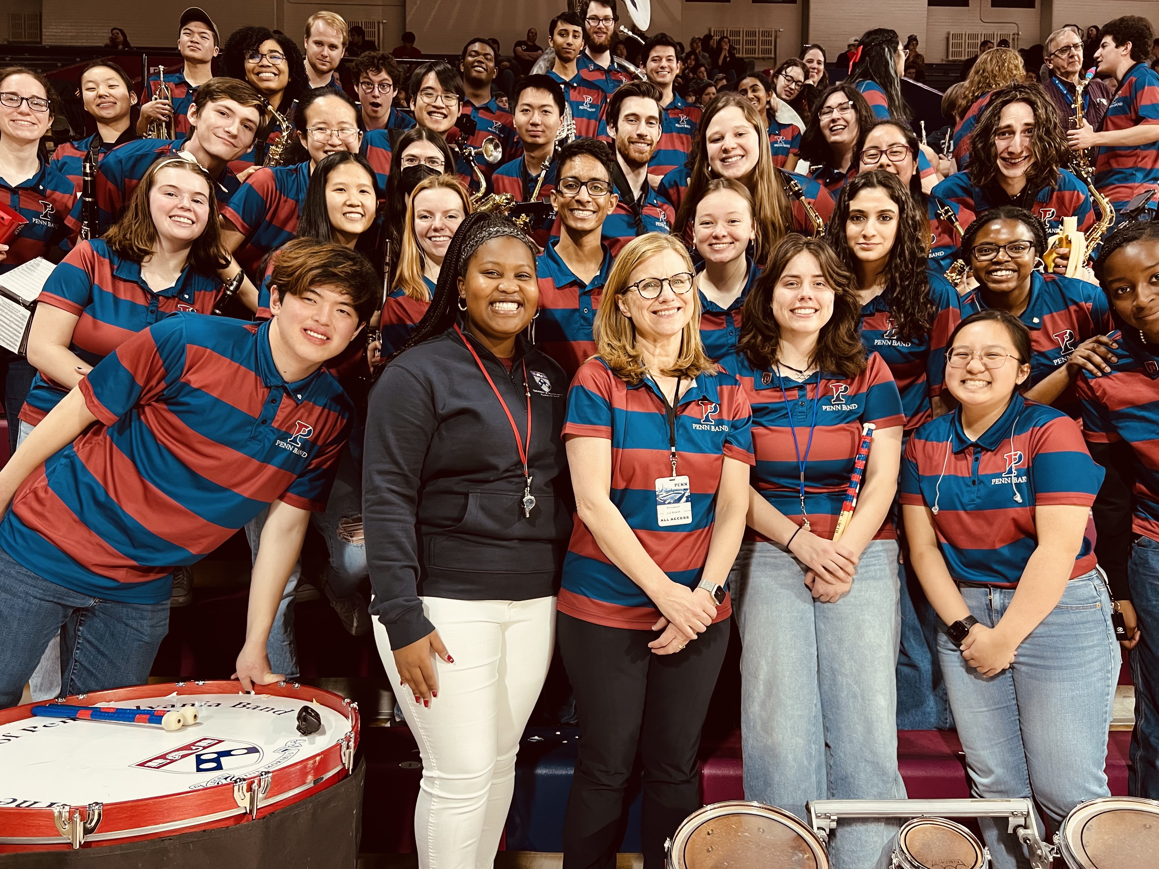 President Liz Magill with conductors of the Penn Band during the men’s basketball game against Cornell on Saturday at the Palestra.