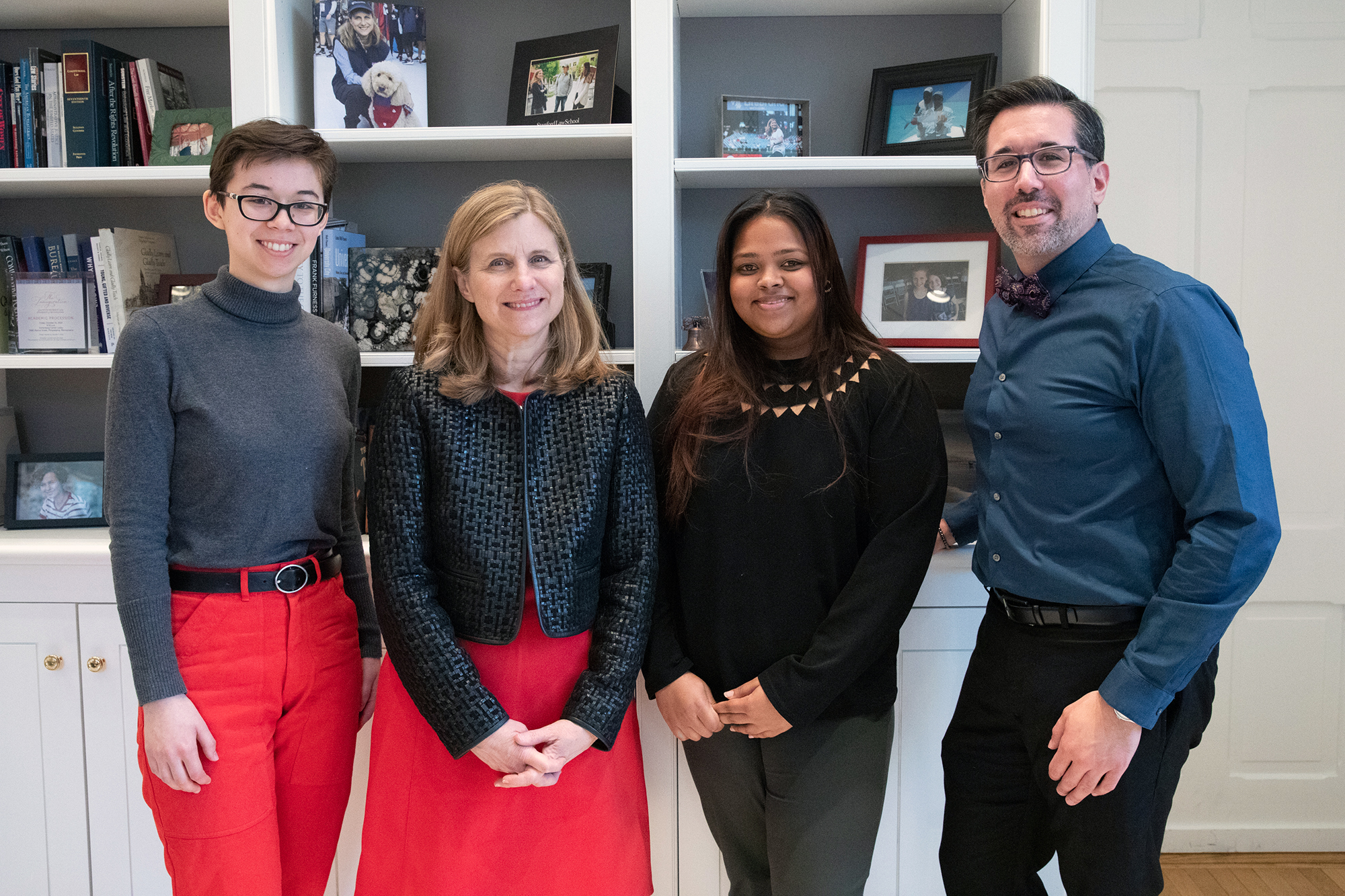 Two students standing with Liz Magill and Mark Lo (right).