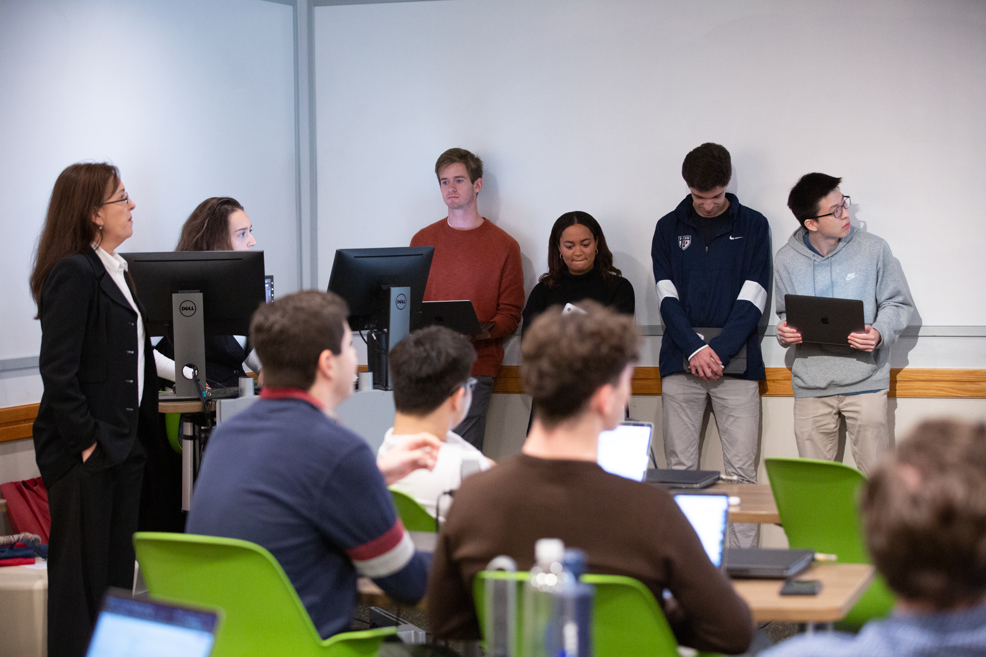 Students stand at the front of a classroom while others sit in seats andawait a debate in the Future of Conservatism class at Penn.
