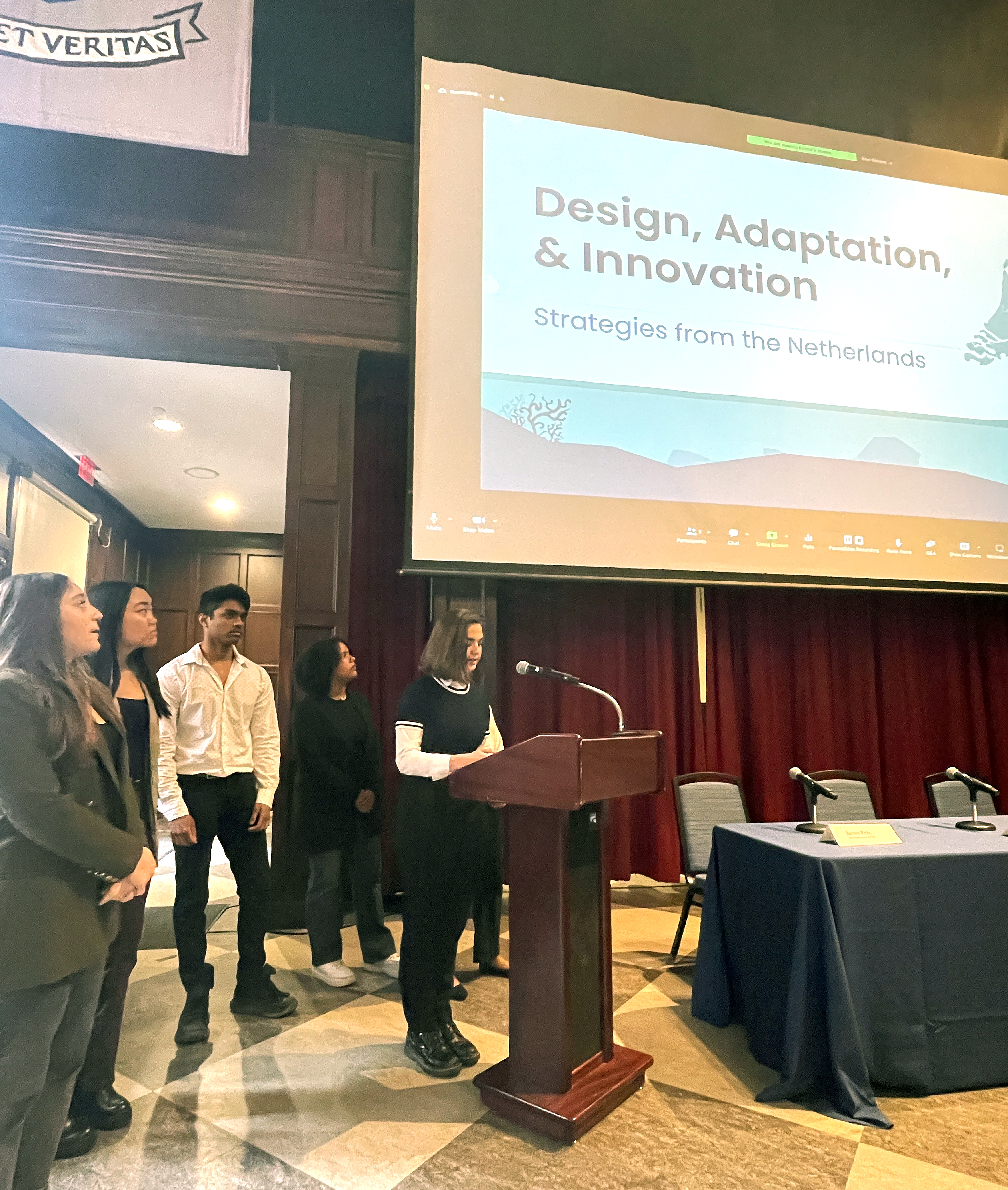 Students give a presentation at a podium titled Design, Adaptation, and Innovation: Strategies from the Netherlands