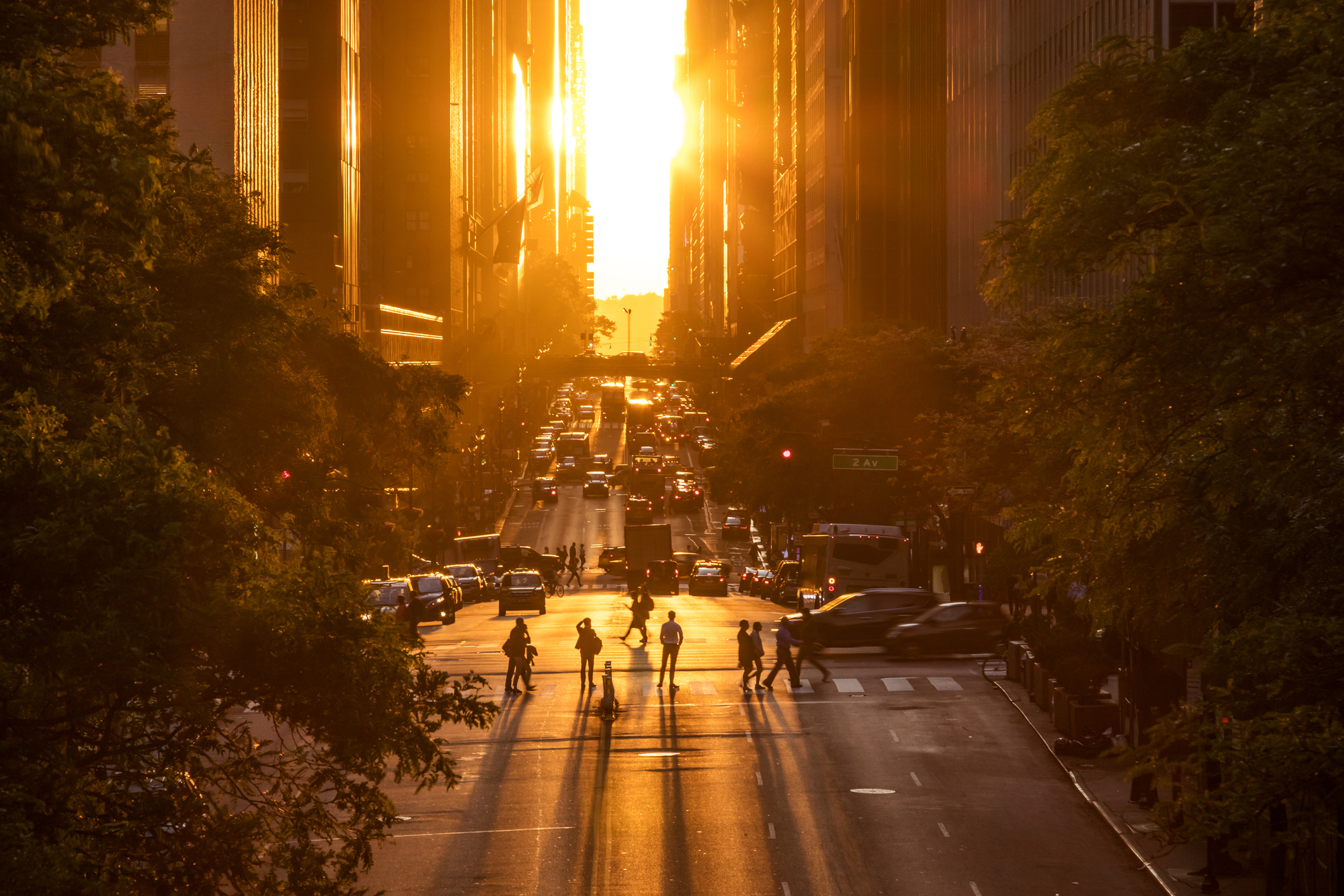 A low sun shines on a city street 