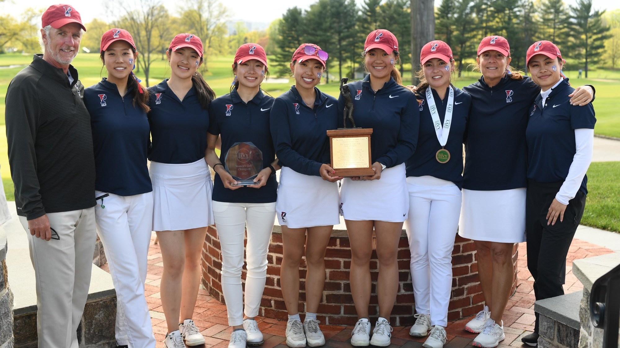 Penn's women's golf team and their coach celebrating first place title.